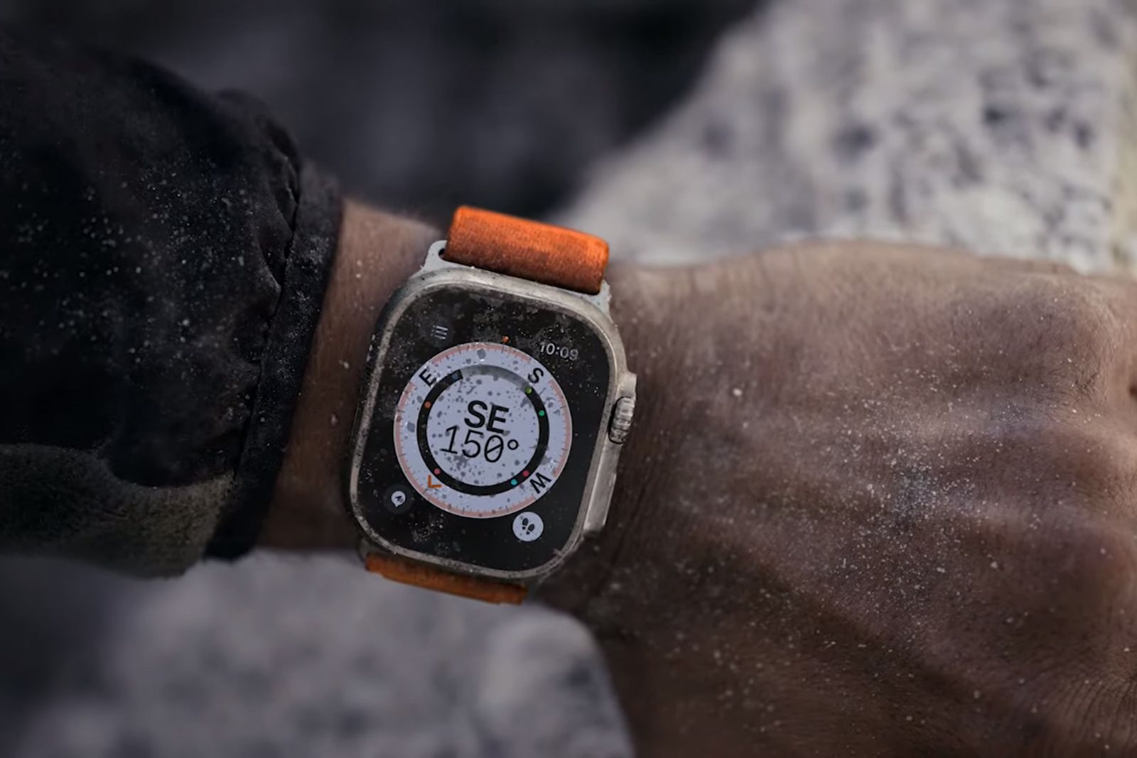 Apple Watch Ultra with orange band on a wrist