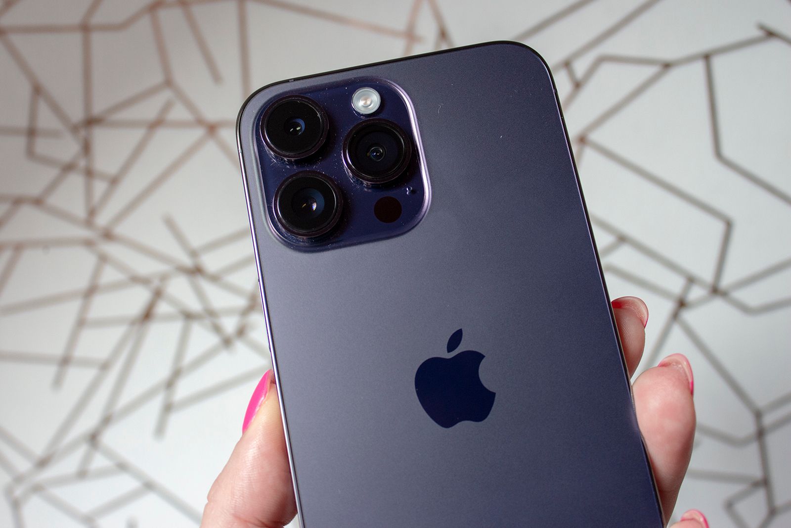 iPhone 14 Pro Max cameras shown on a deep purple handset