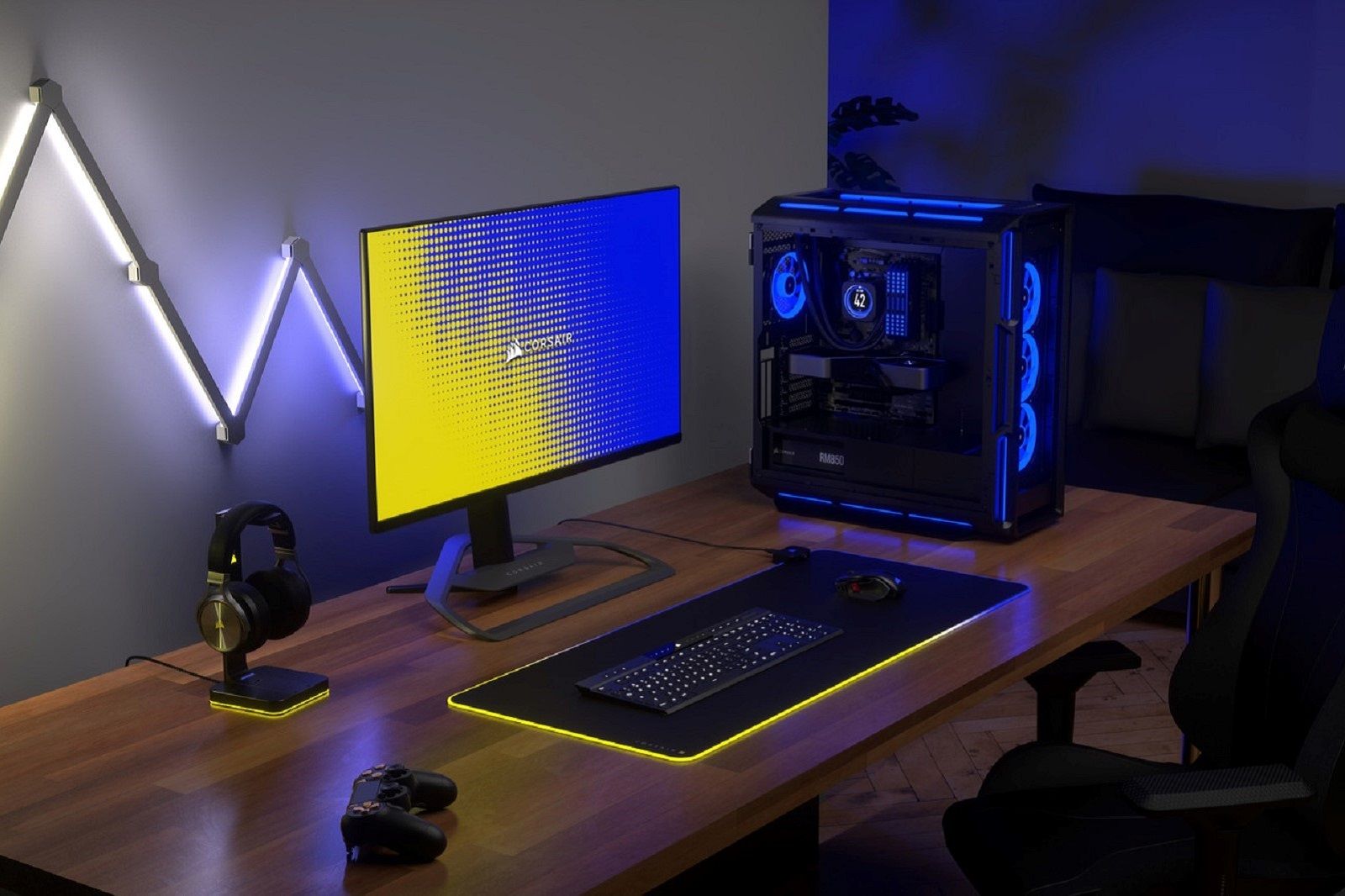 PC, monitor, keyboard, and headphones on a desk with RB lighting elements