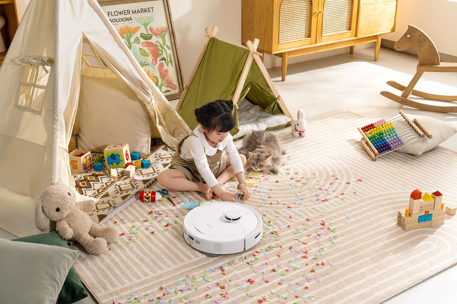 The Roborock Q Revo vacuum cleans while the little girl plays with toys