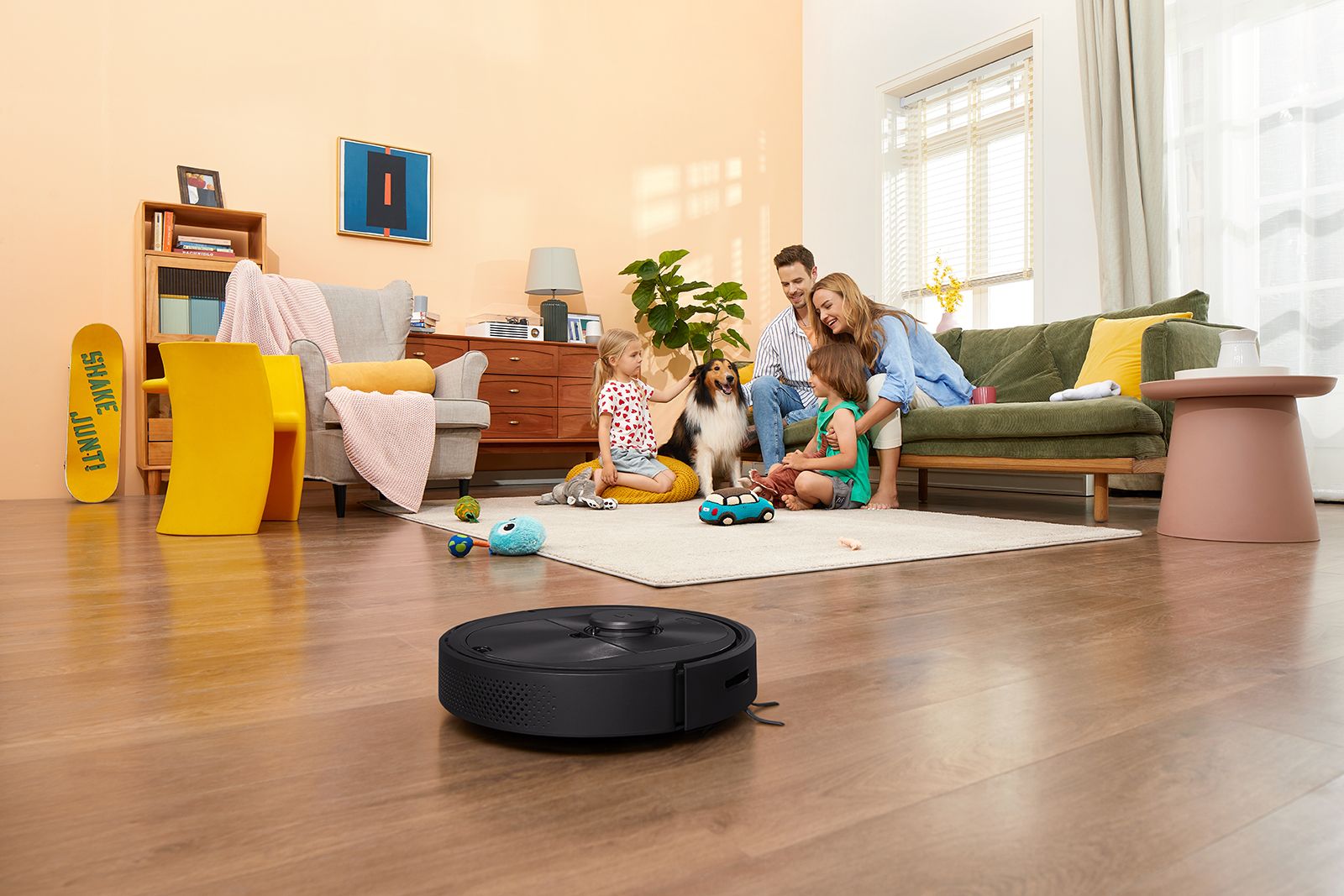 The Roborock Q5 vacuum cleans while the family plays