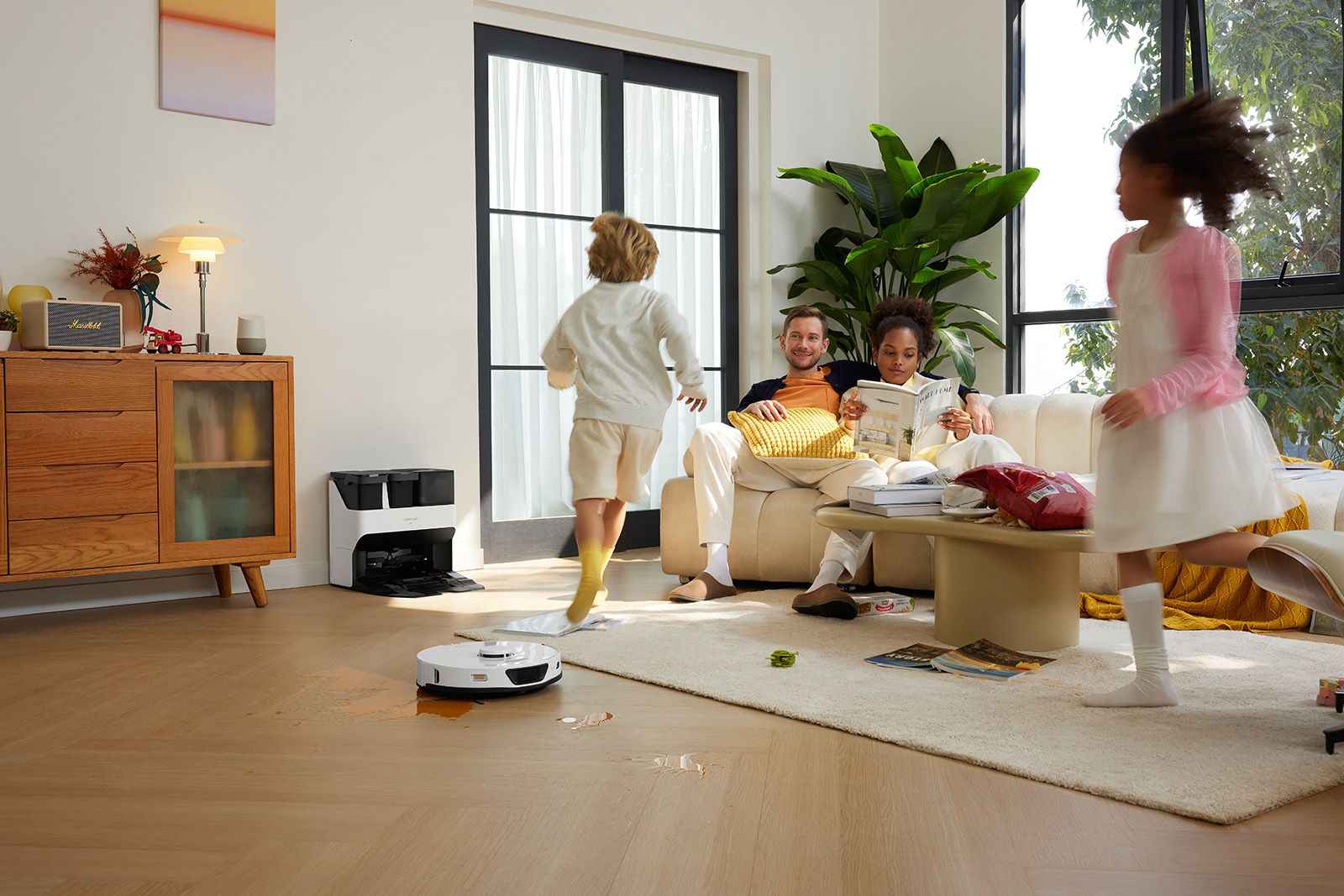 A family relaxes while the Roborock S7 Max Ultra vacuum cleans