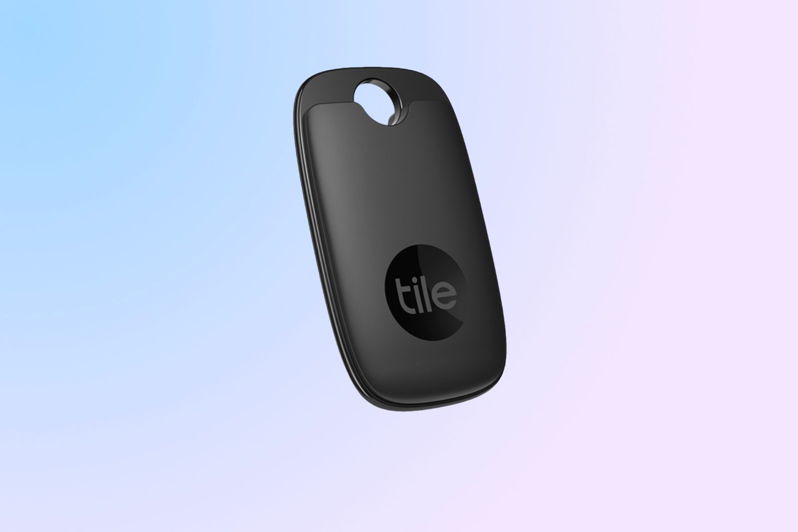 The oval keychain-shaped Tile Pro Bluetooth tracker over a bluish-pink background with it's 