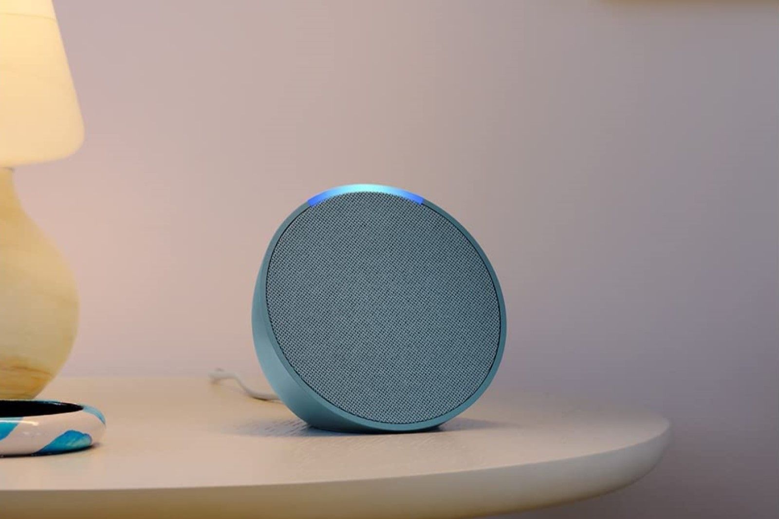 Amazon Echo Pop on a bedside table