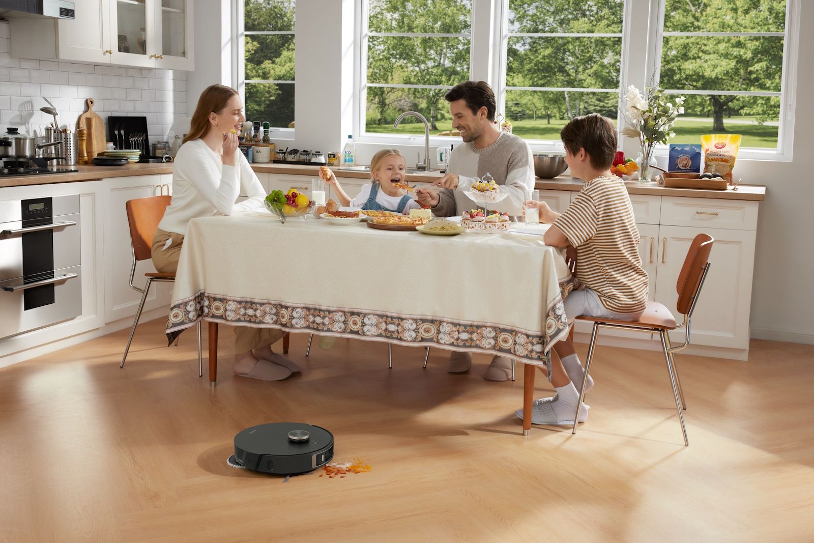 dreamebot l20 ultra on floor cleaning mess with family eating at table