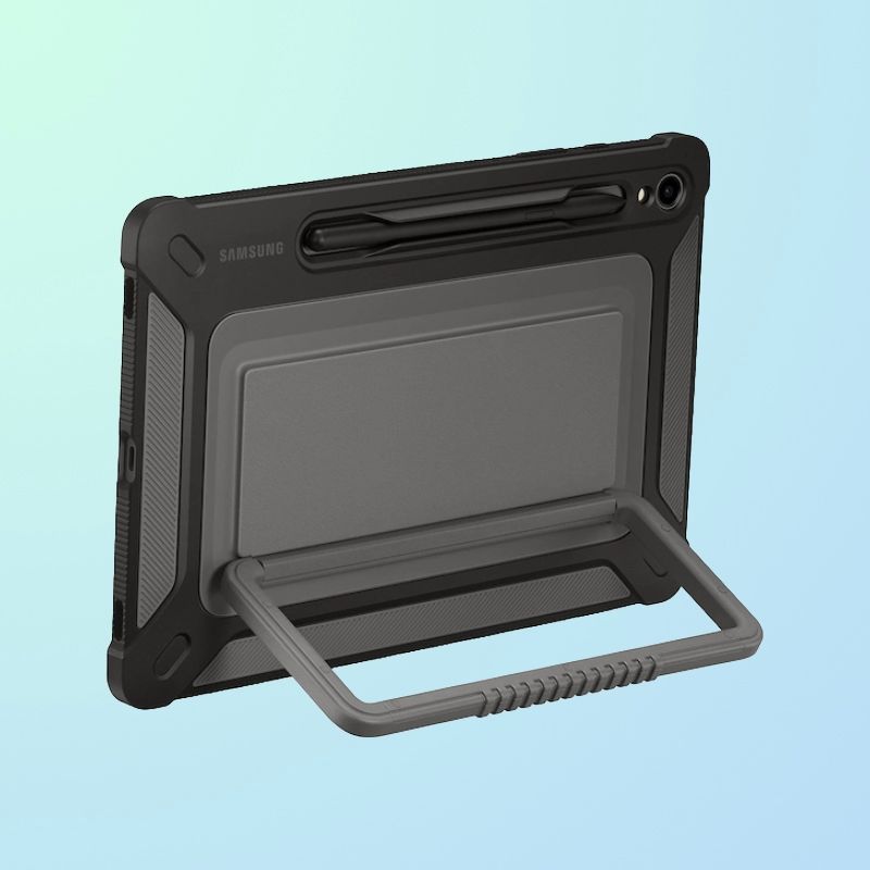 The back of a tablet in a rugged case with a handle stand, camera, and stylus visible.