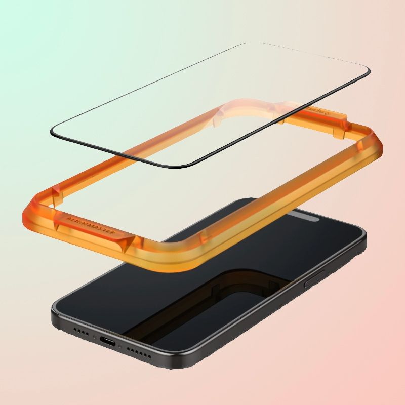A orange alignment mount and tempered glass screen protector lowering onto an iPhone 15 Plus.