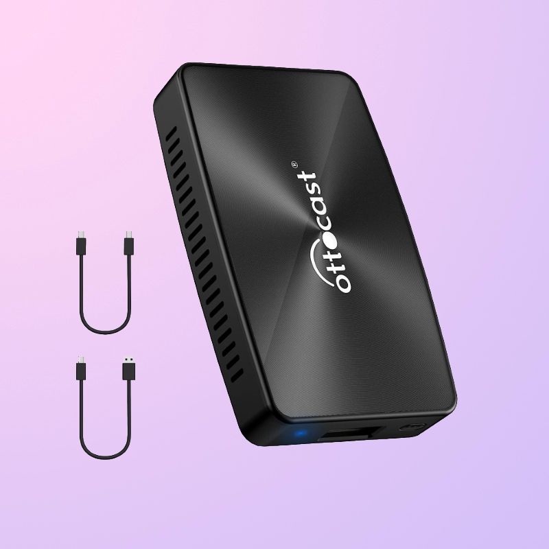 A rectangular box with slits on the side, a logo on top, and two small cables on the left side.