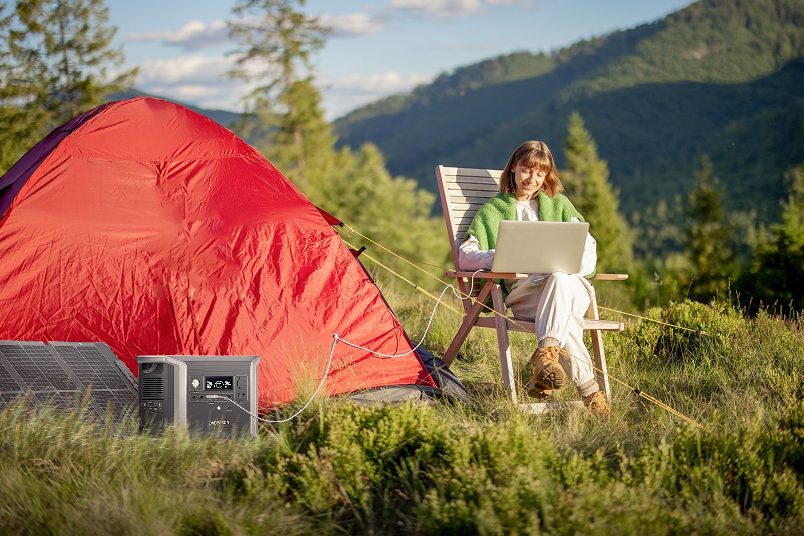 A woman camps with a red tent and uses a laptop