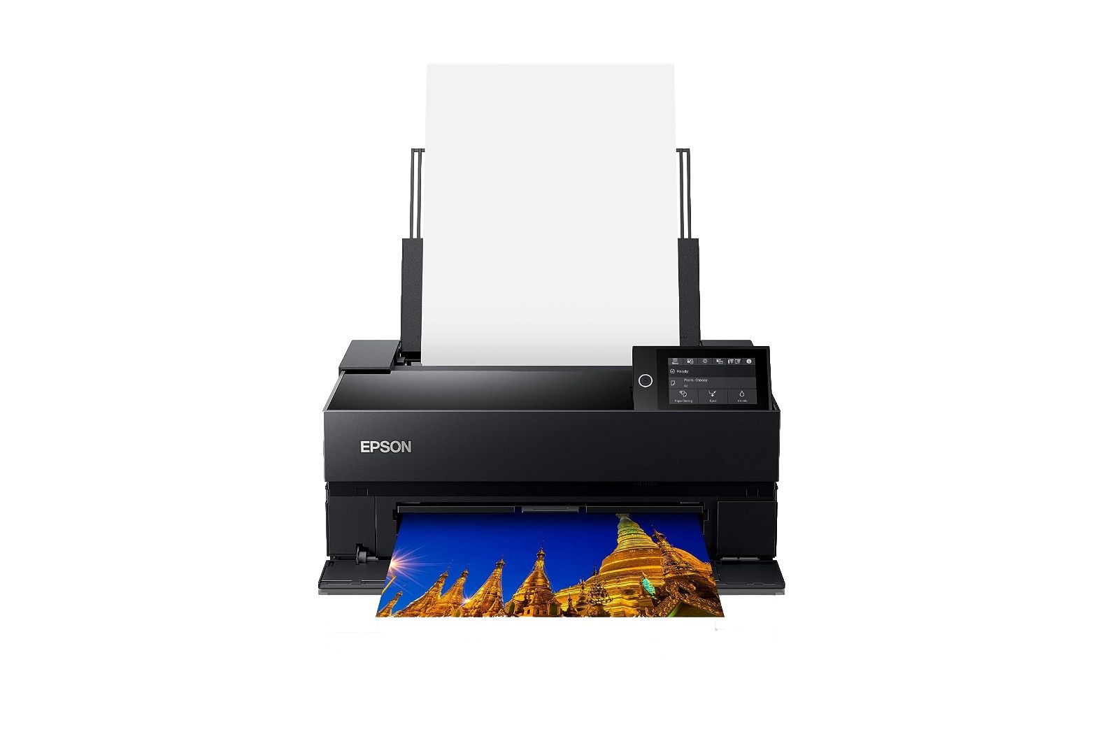 A rectangular black printer with a big sheet of photo paper coming out of the top.