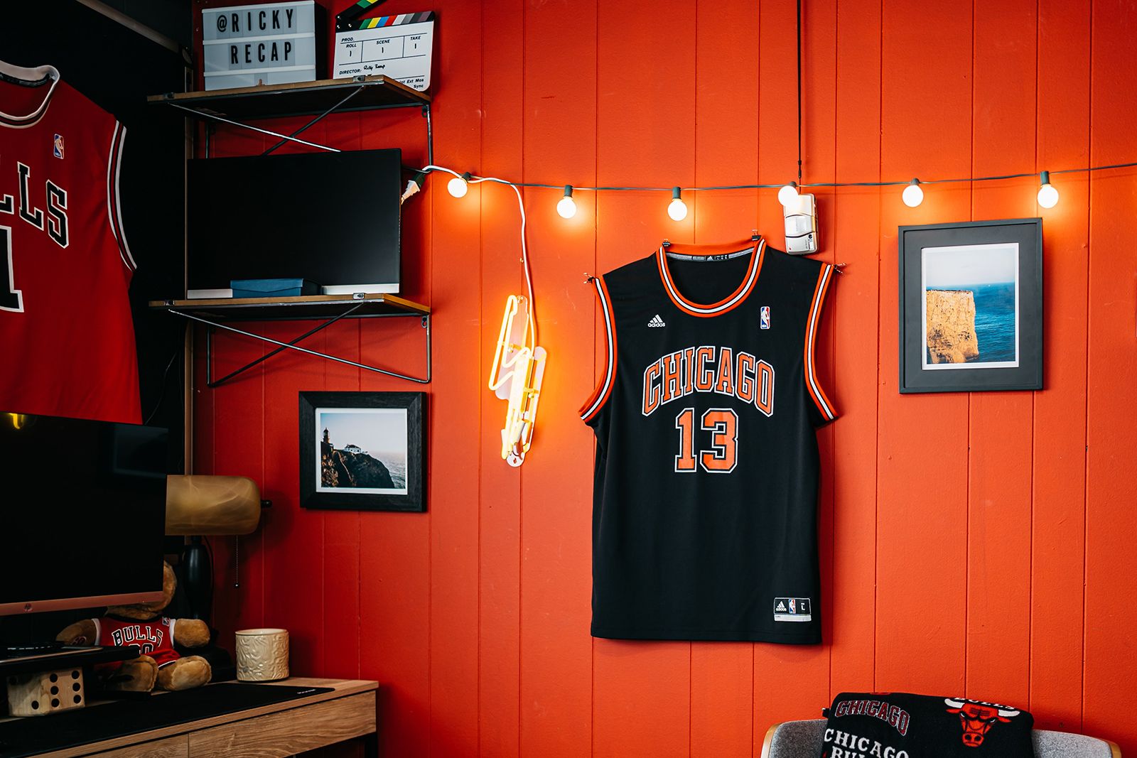 Red office wall with string lights and Chicago Bulls jersey