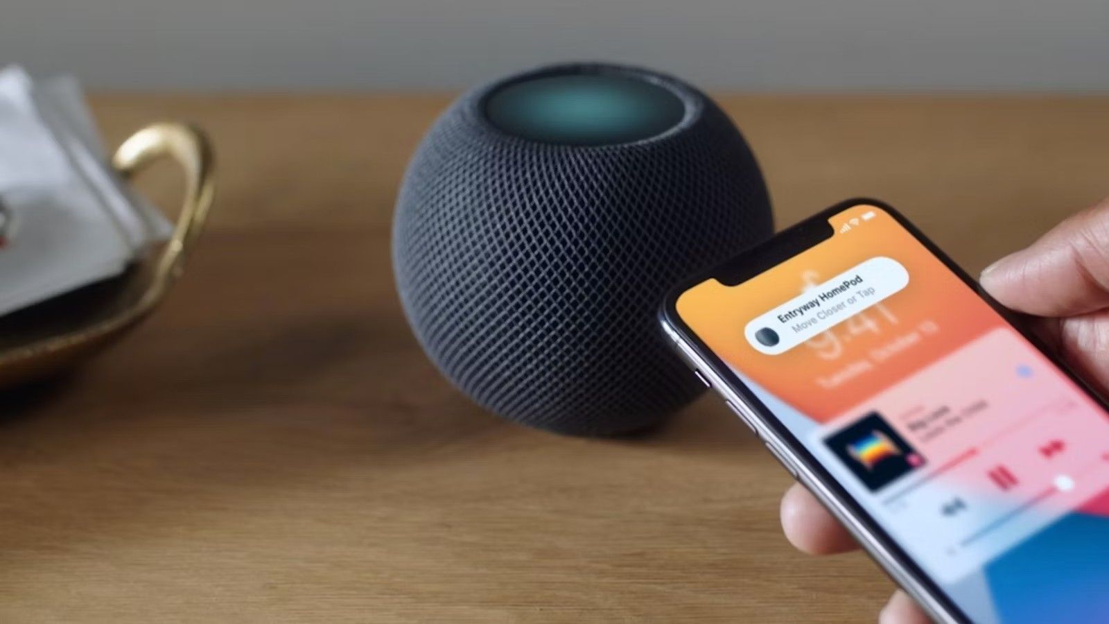 An iPhone hands off a song to a HomePod Mini 