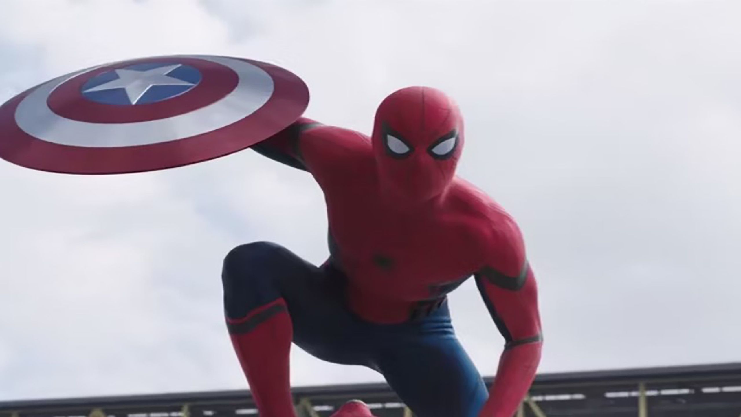 Spiderman holding Captain America's shield