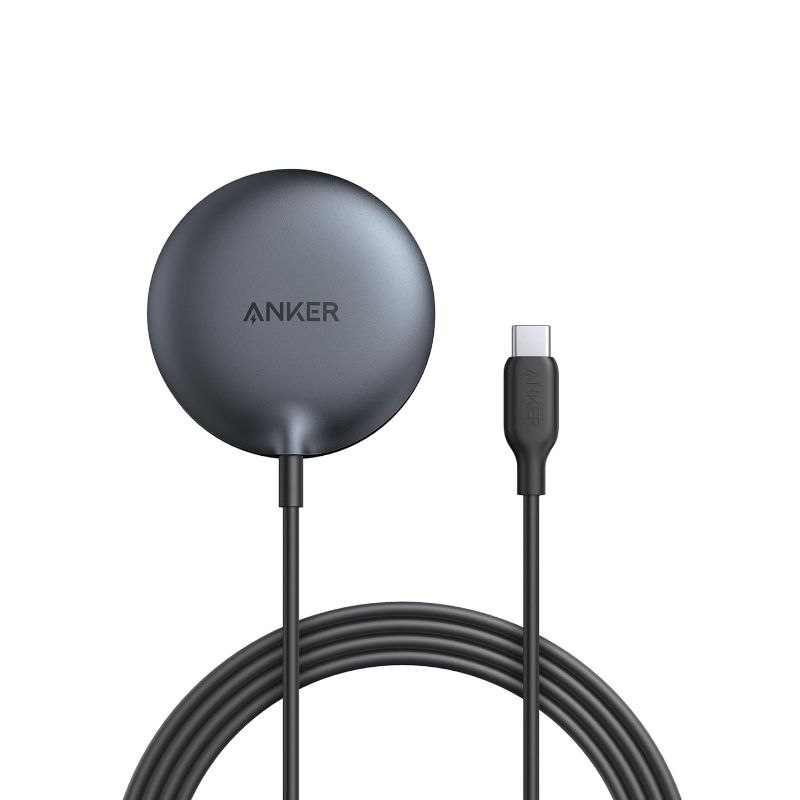 A circular grey wireless charging puck with a long cable.