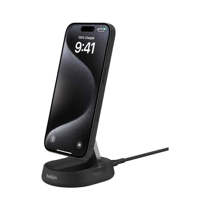 A iPhone 15 on a Belkin charging stand with a cable coming out of the back.