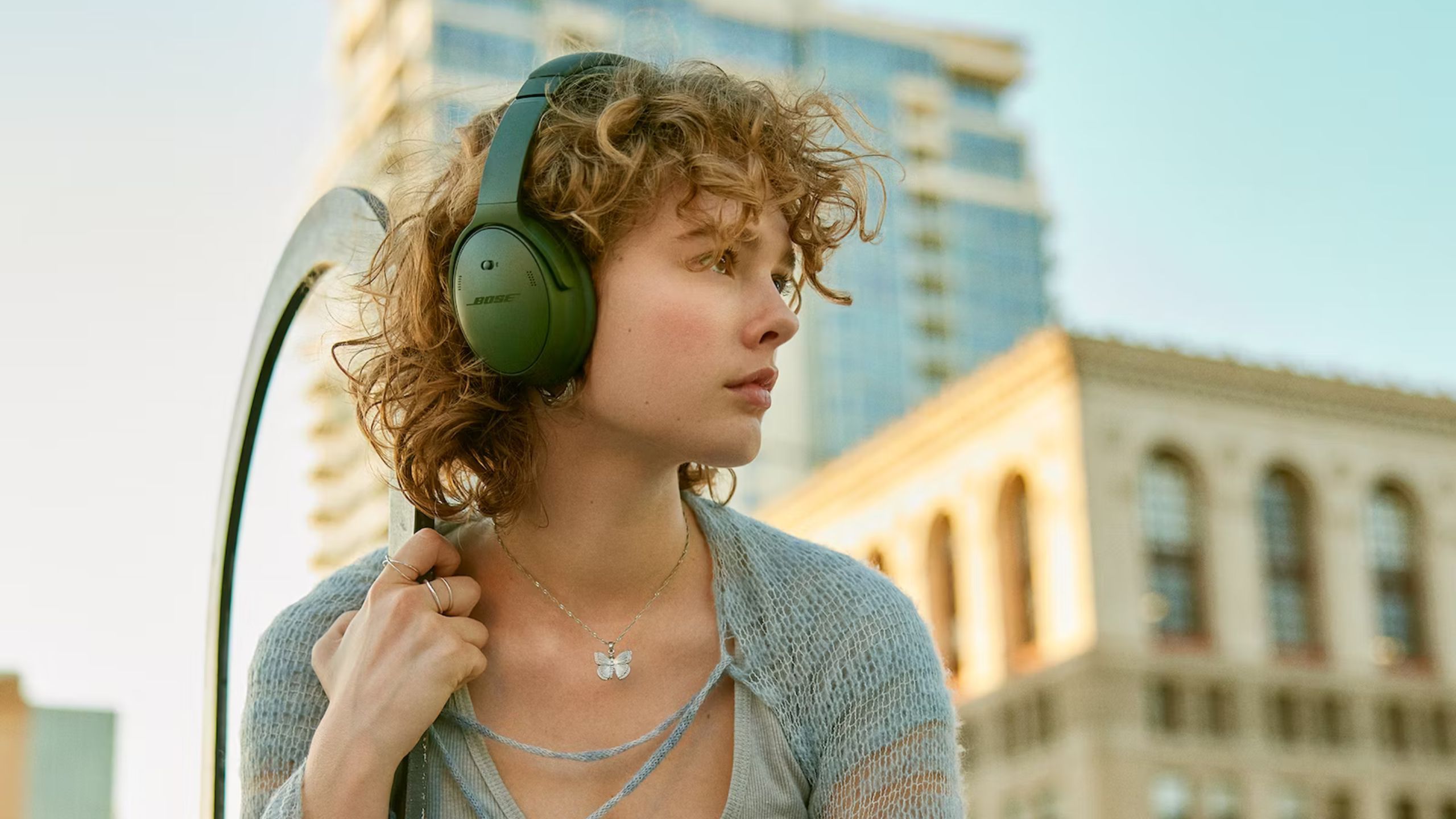 Bose Quietcomfort lifestyle image woman with green headphones