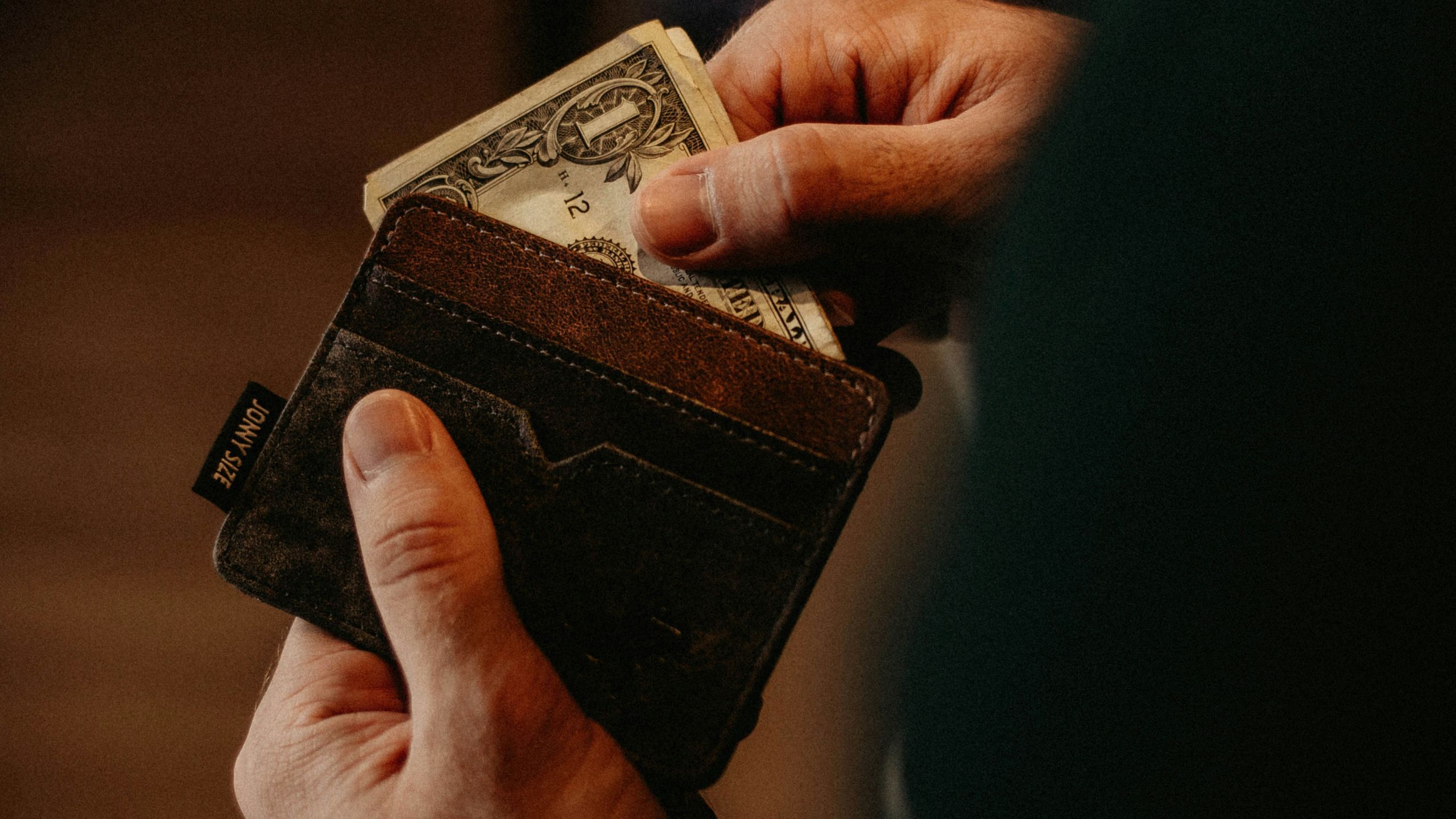 Person getting money out of a wallet 
