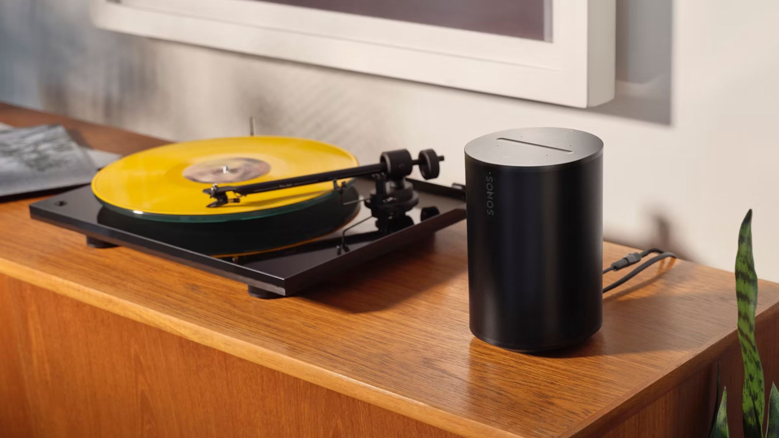 A record player attached to a Sonos Era 100 speaker.