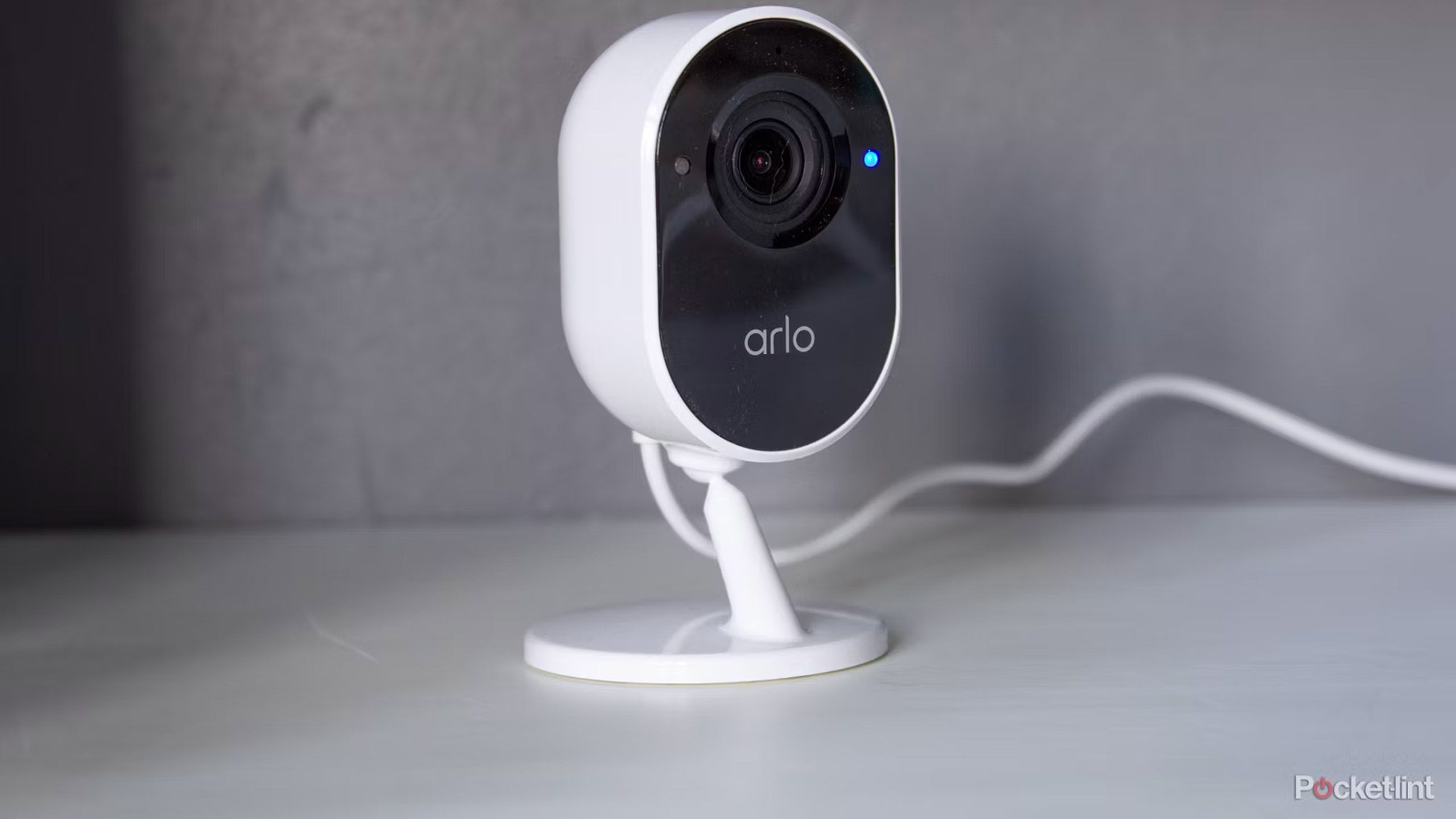 An Arlo Essential Indoor camera sits on a table
