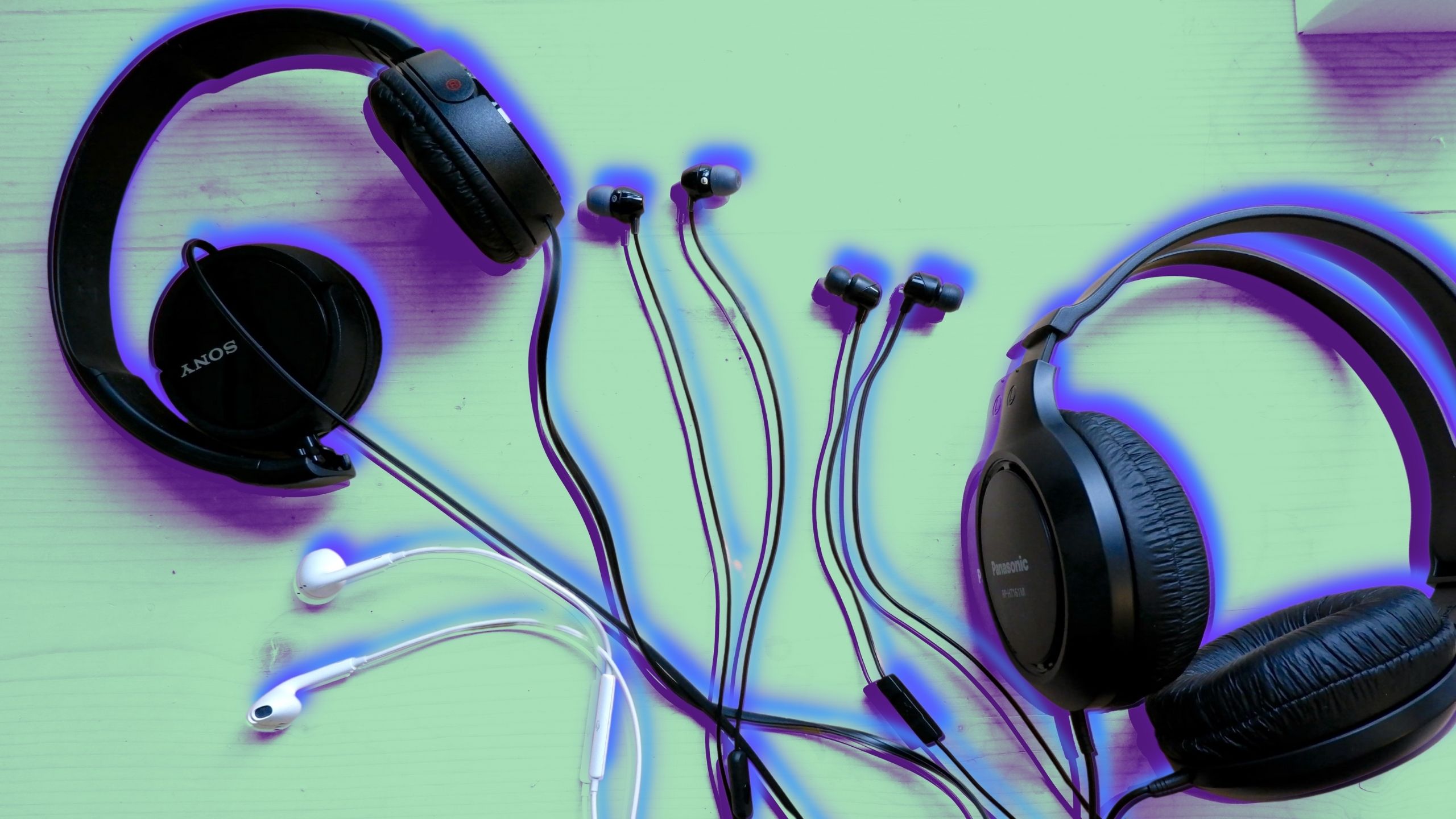 Different pairs of headphones with a purple and blue overlay