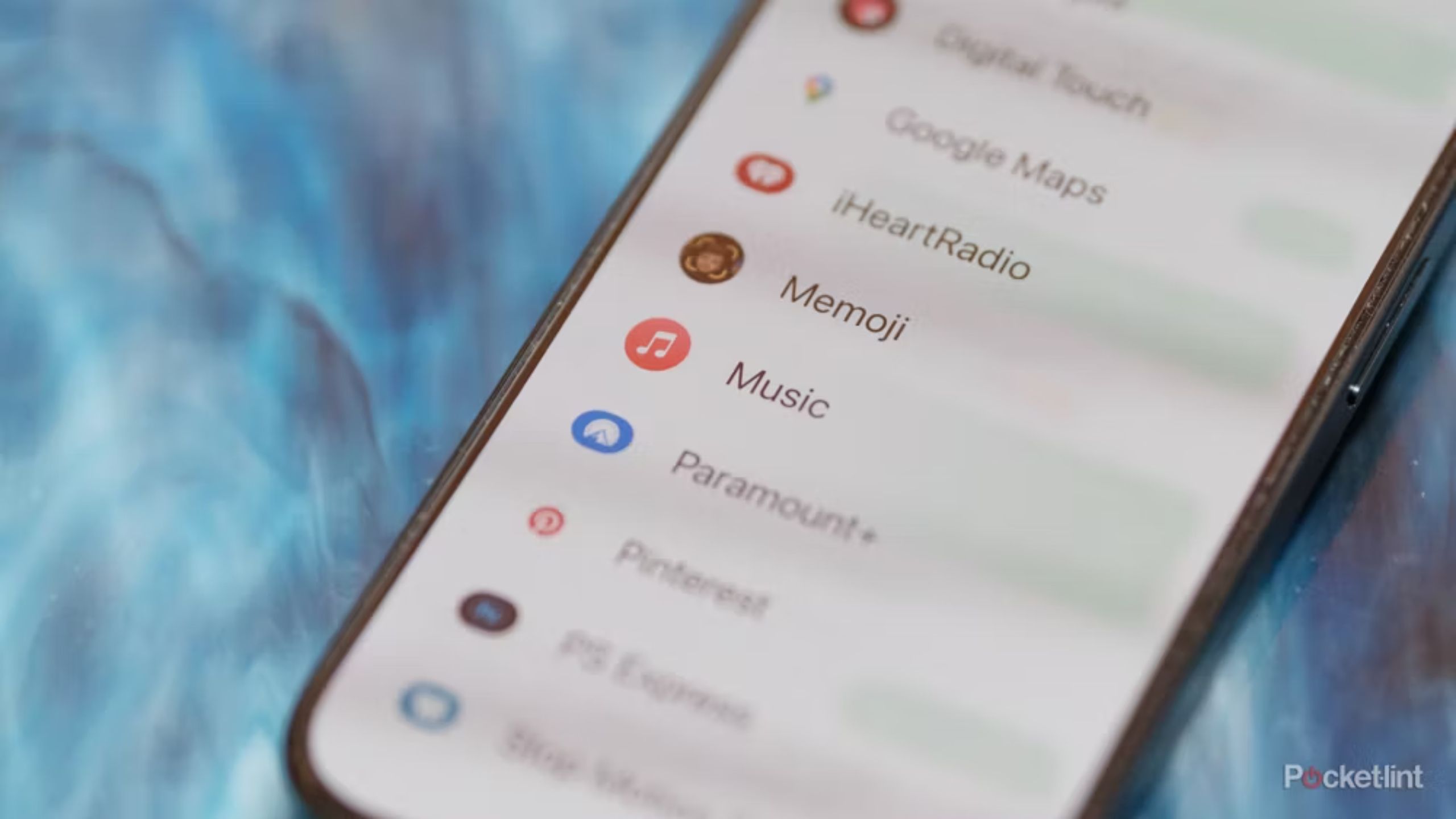 iPhone iMessage menu displaying iHeartRadio, Memoji, Music, and more options. 
