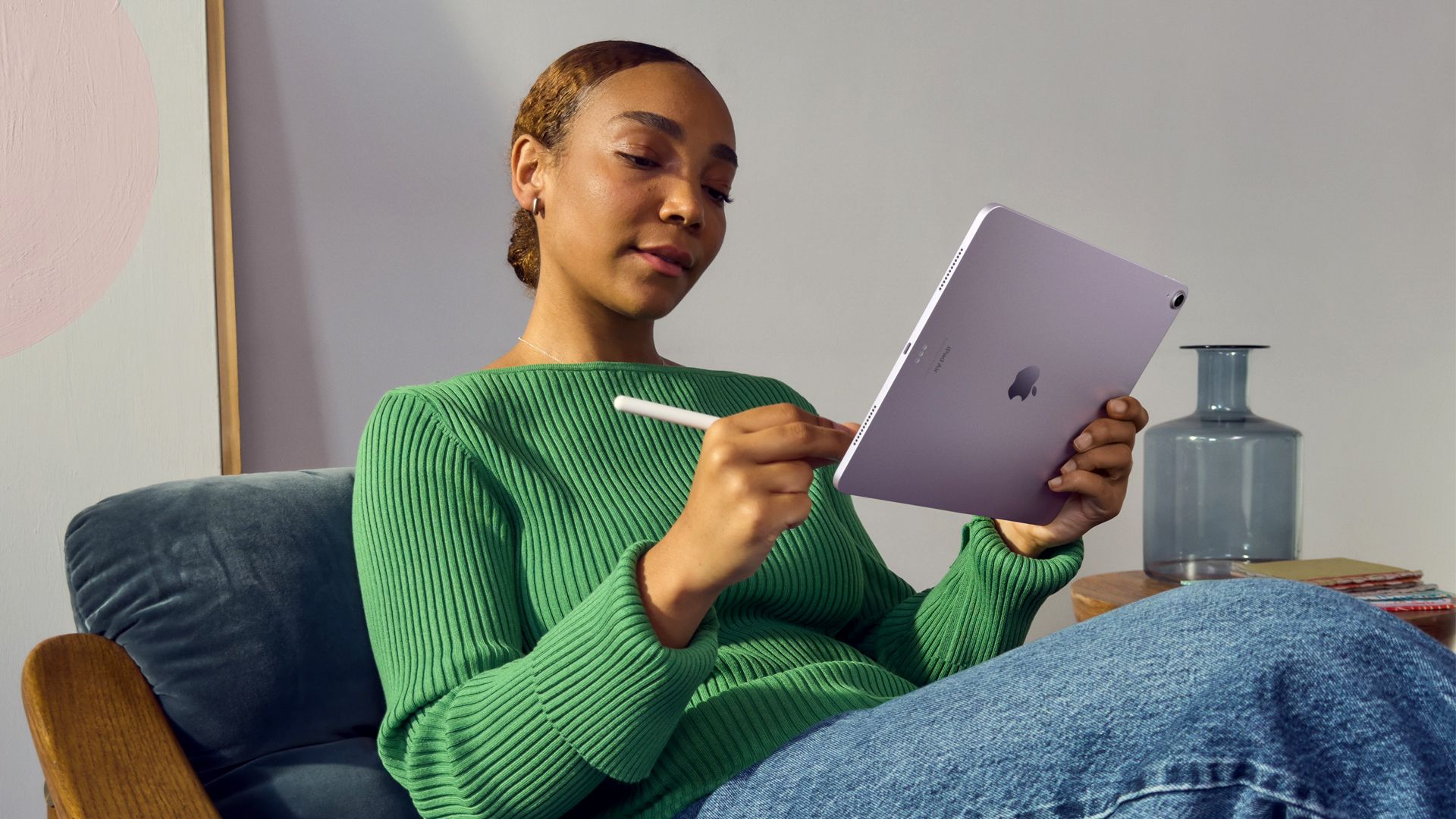 A woman drawing on a 2024 iPad Air.
