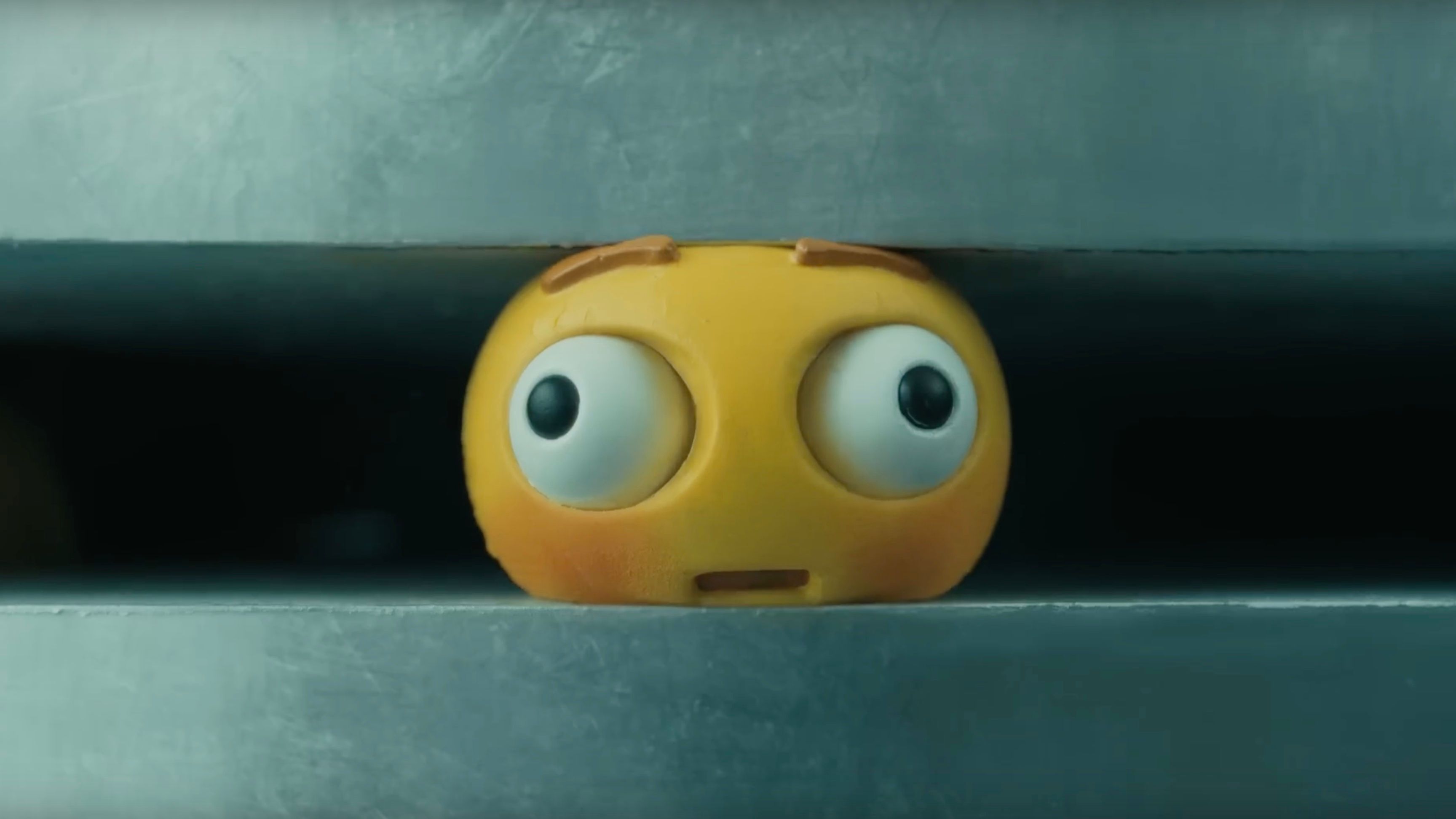 A screenshot from Apple's Crush ad for iPad Pro, showing an emoji being crushed by a hydraulic press