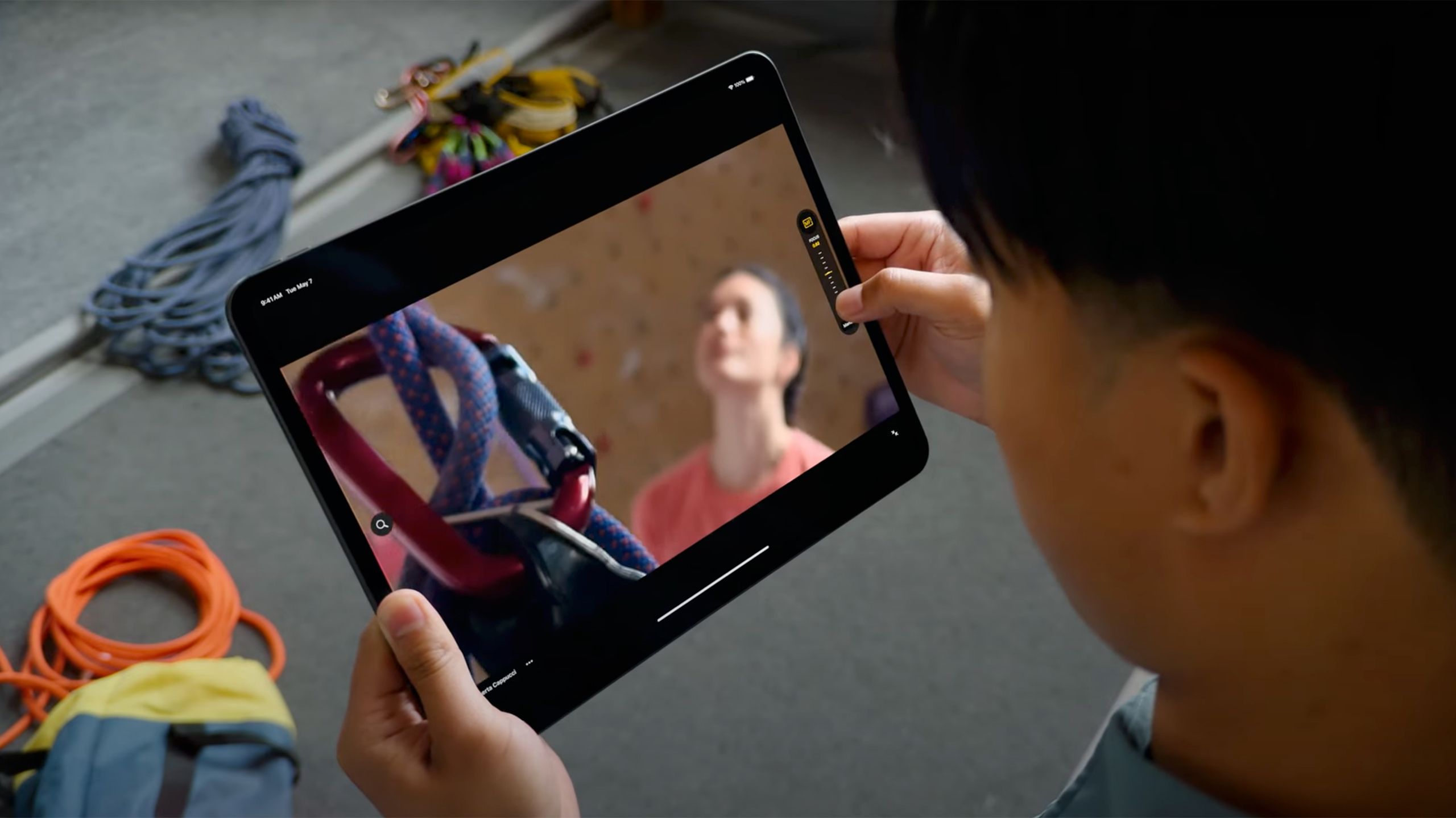A person looks down at an iPad Pro with the Final Cut Live Multicam feature up. 
