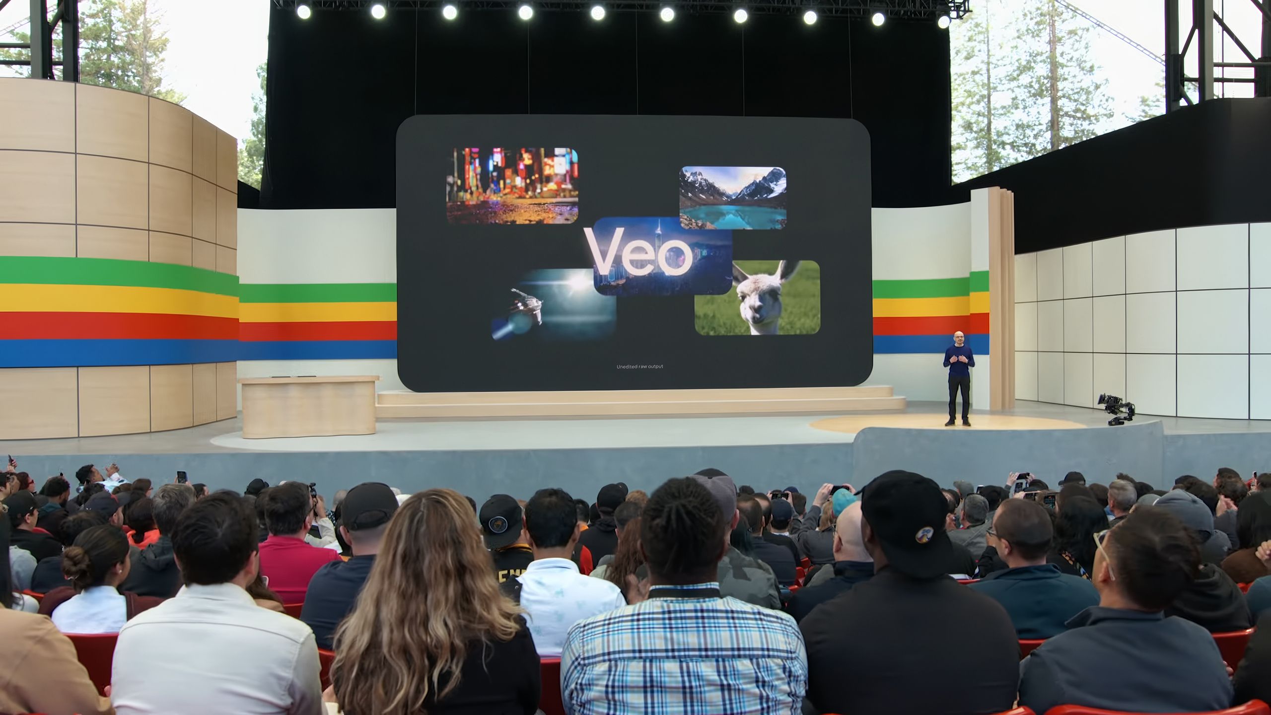 A crowd looks on to a presentation of Google Veo.