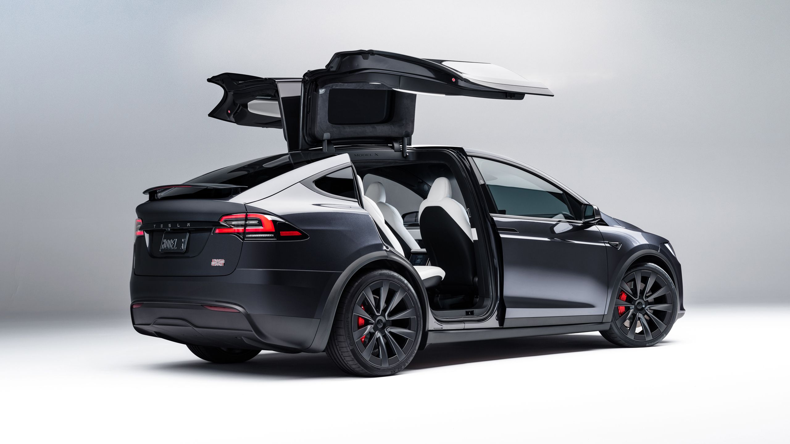 A Tesla Model with its rear doors open.