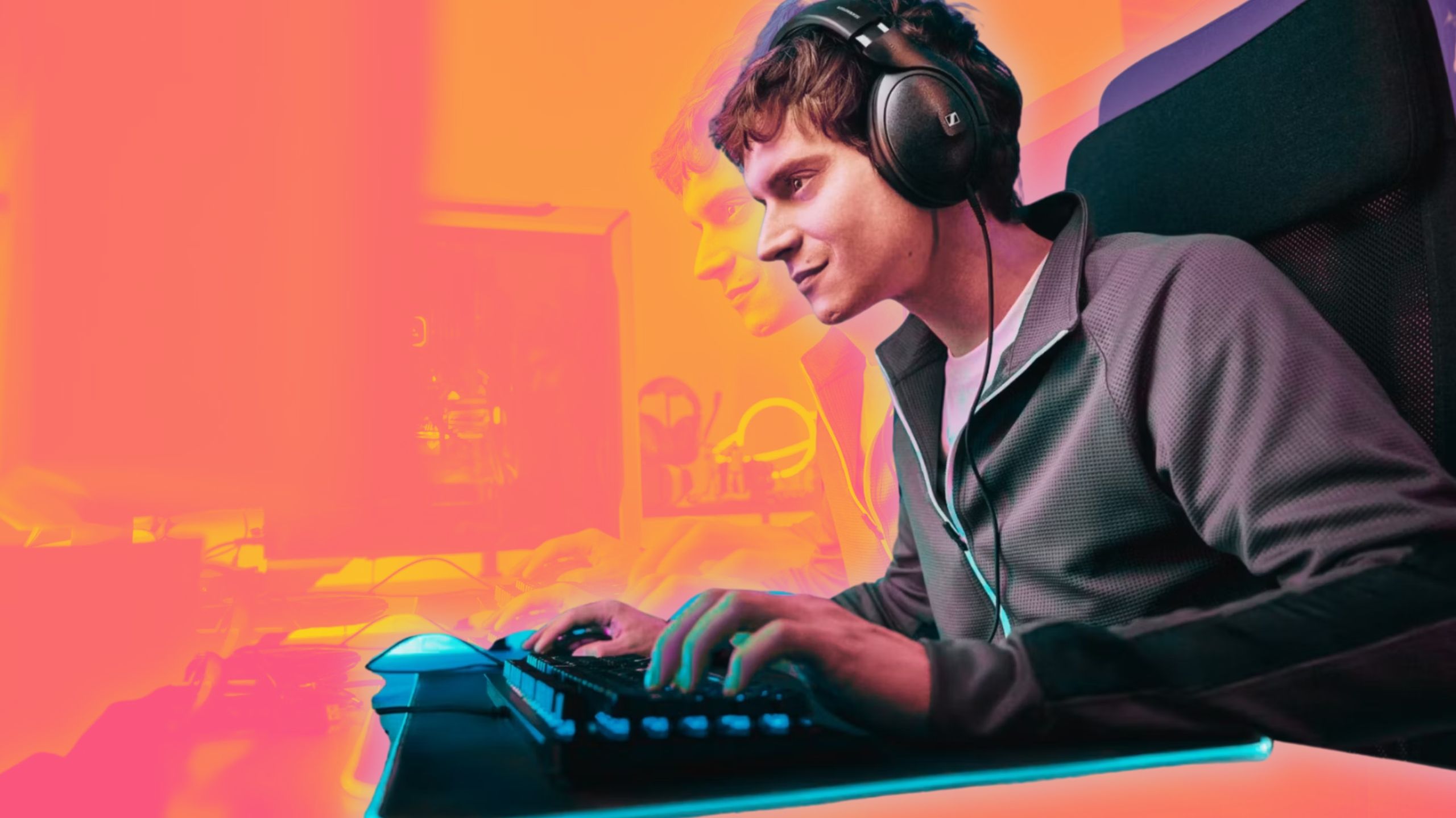 A person sits at a desk and plays a game on a PC wearing Sennheiser HD 620S headphones.  