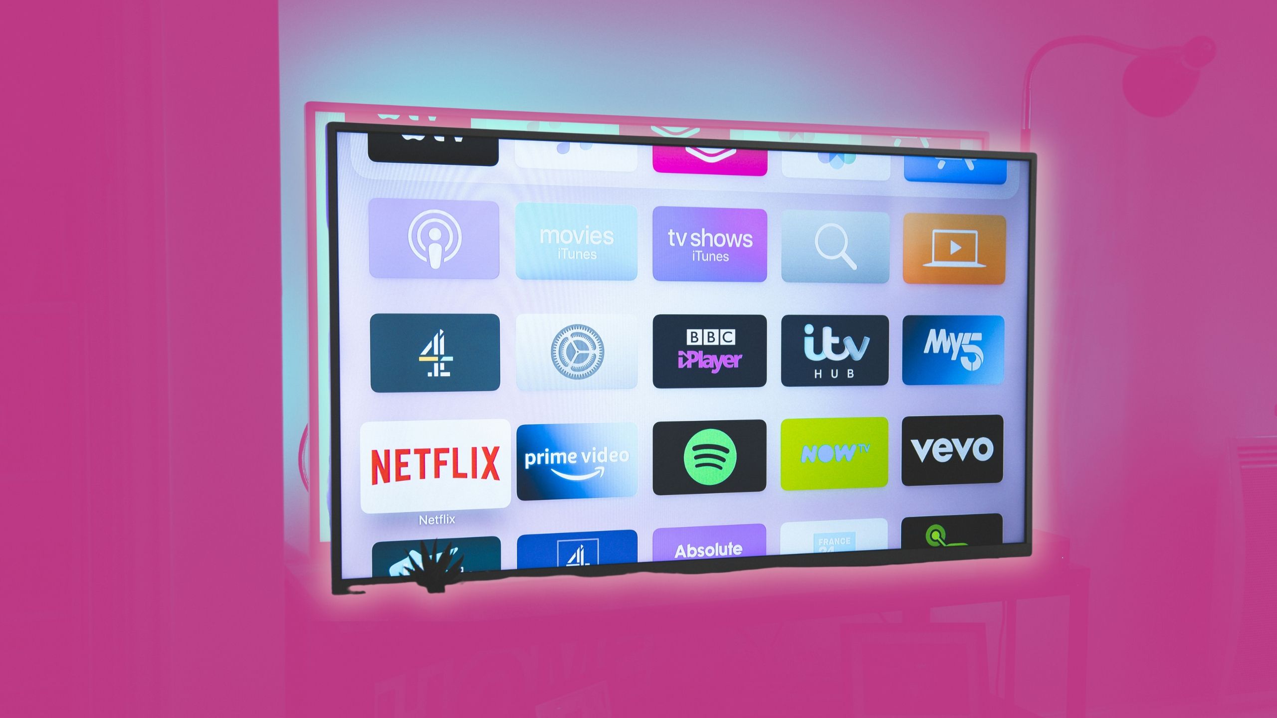 Smart TV apps on a TV on a pink background 