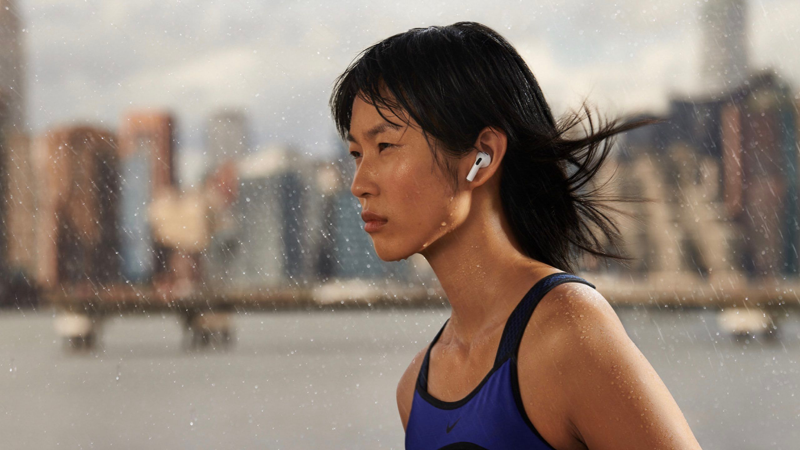 A woman wearing 3rd generation AirPods in the rain.