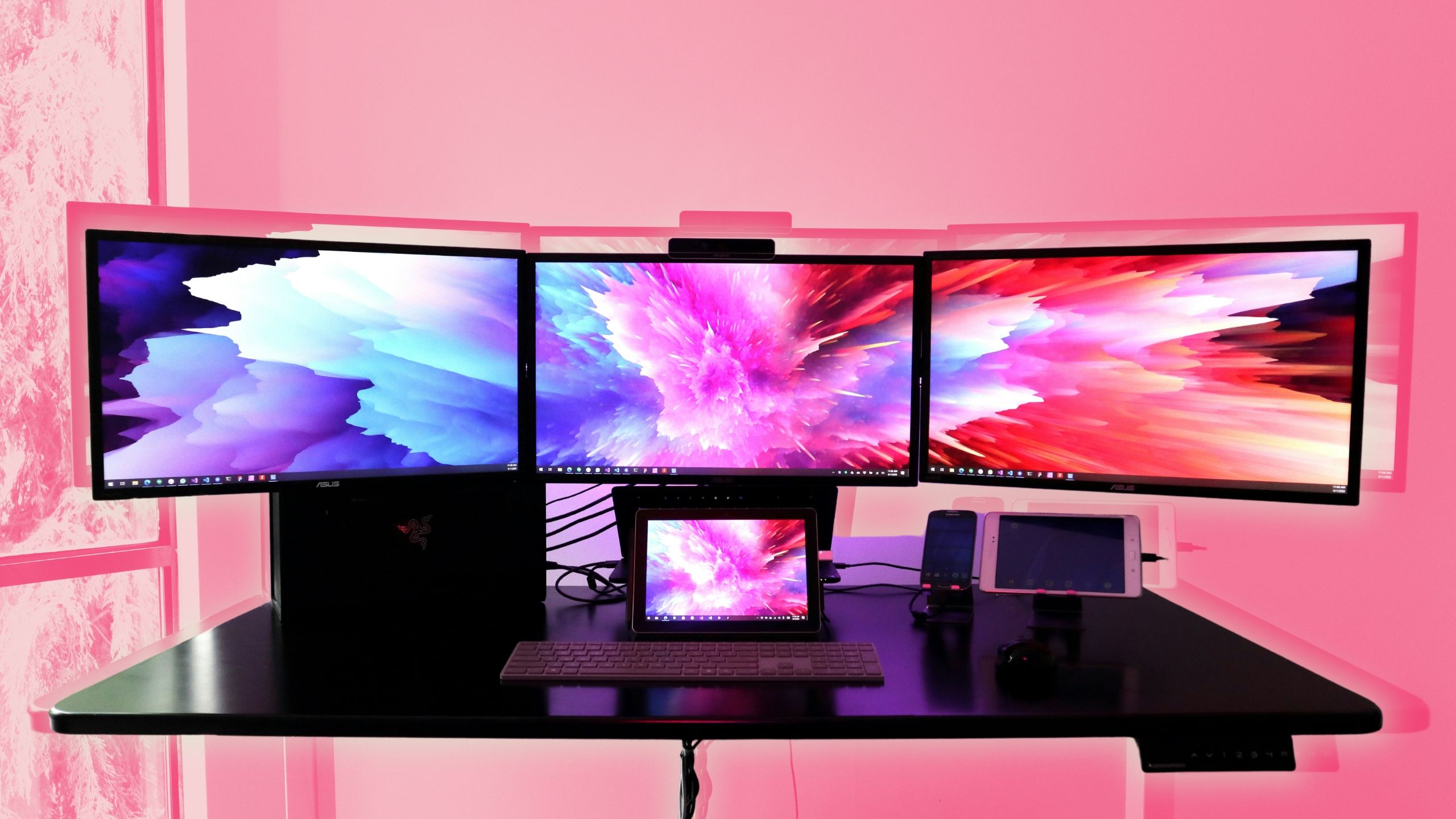 Three monitors on a desk