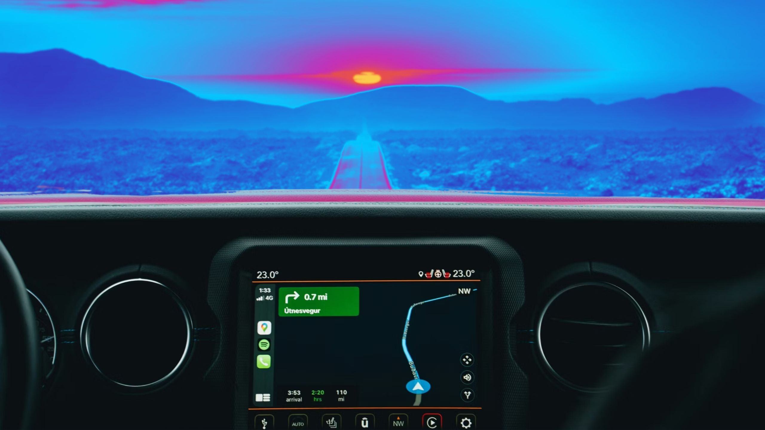 Carplay with a long straight road ahead at sunset