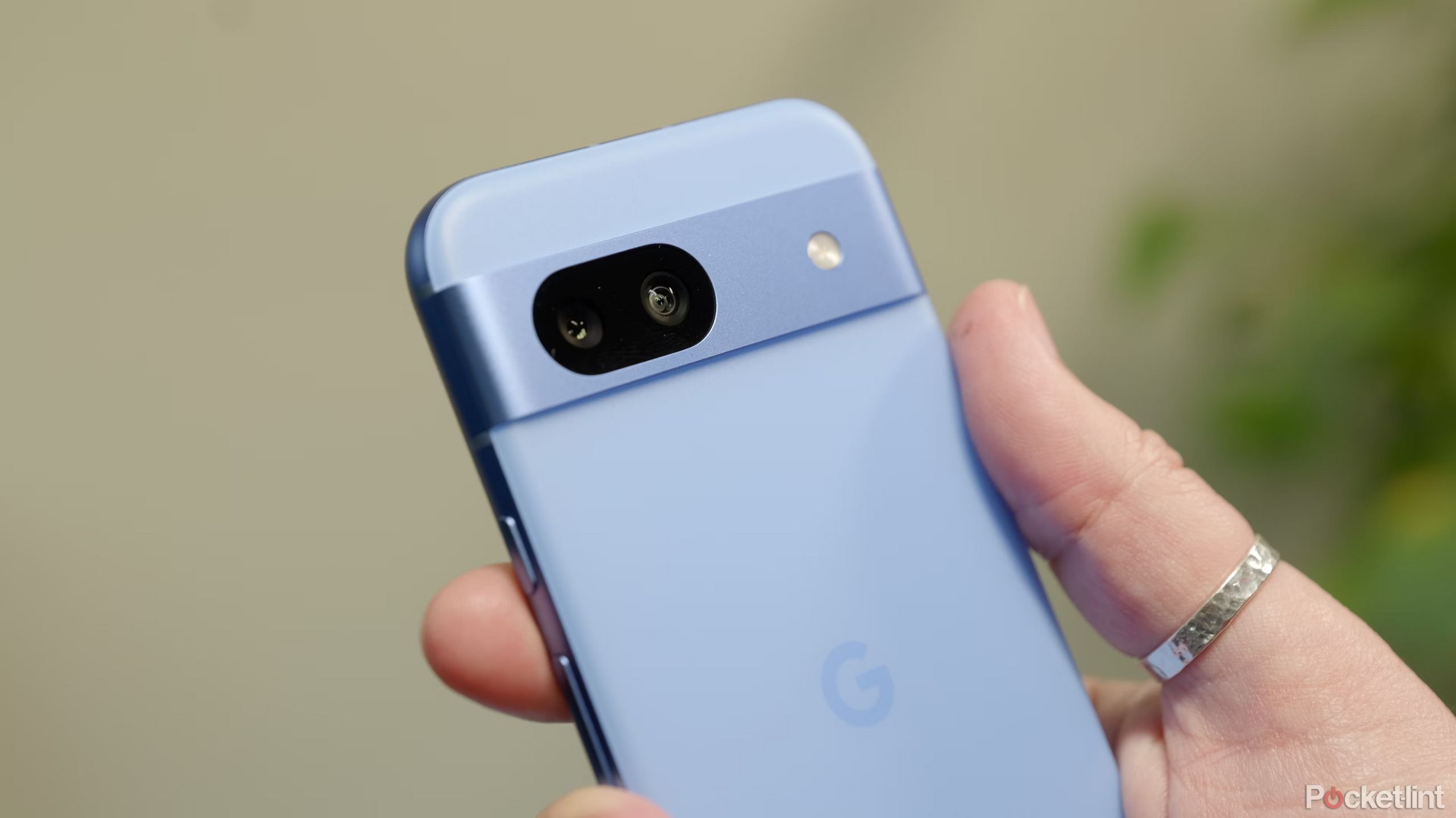 Pixel 8a in hand with the camera facing the viewer. 