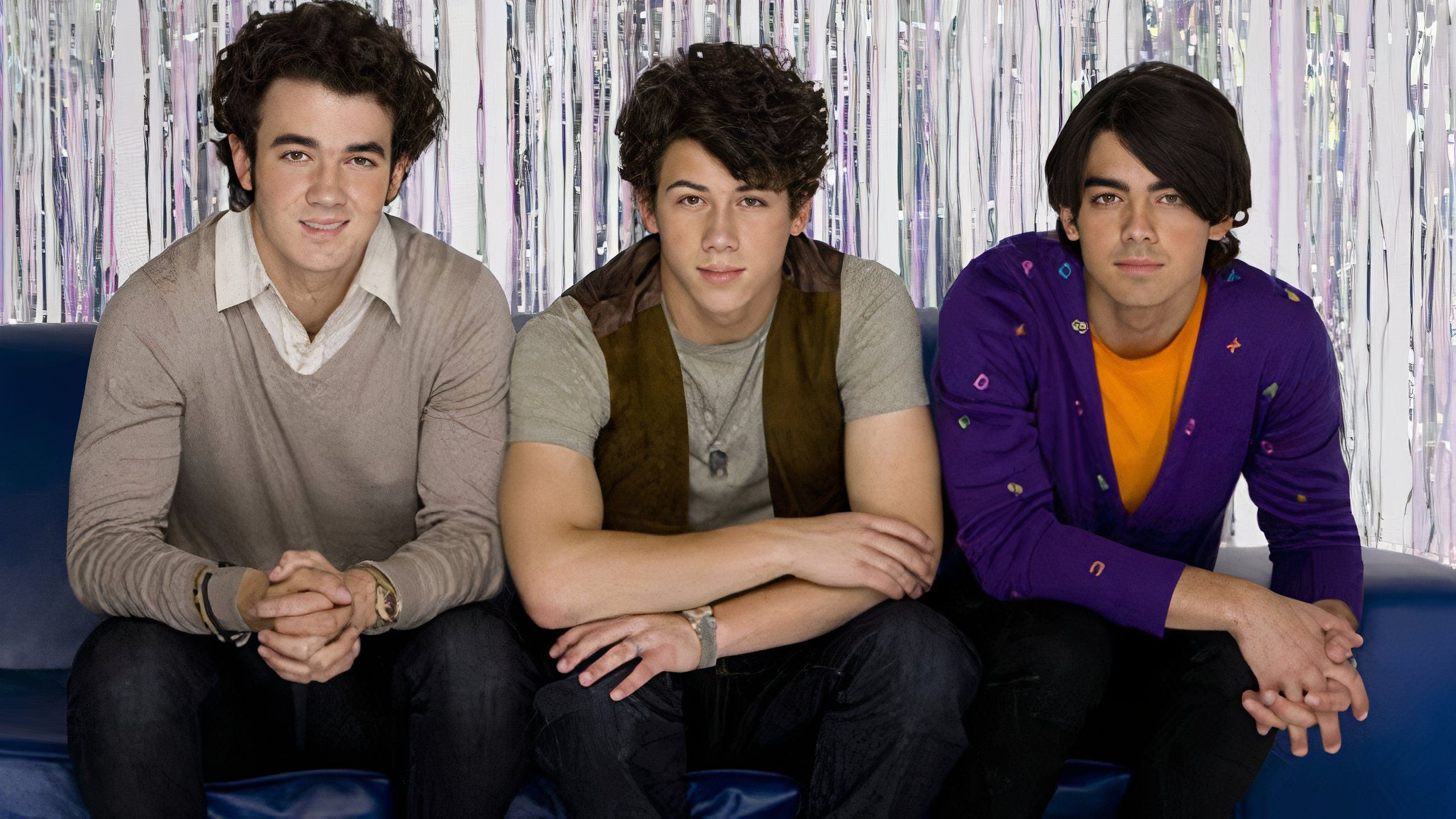 jonas brothers sitting on a couch