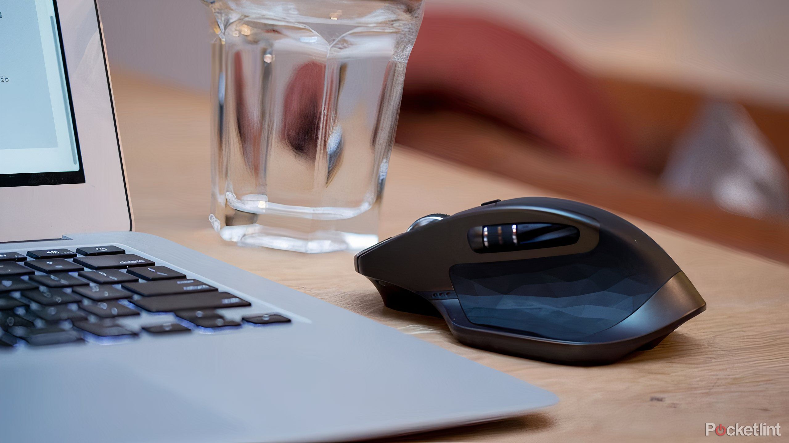 Computer mouse next to a laptop