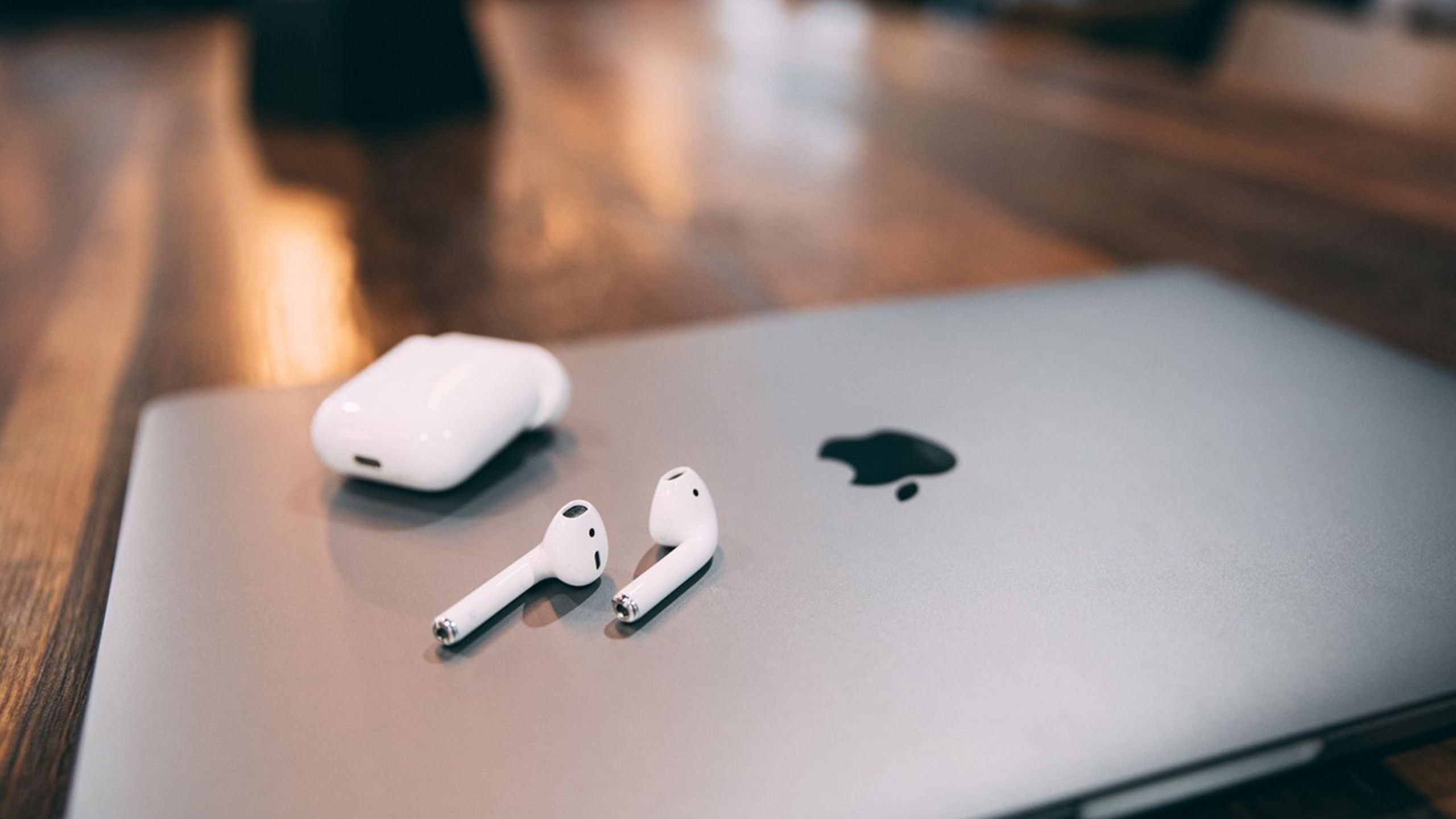 AirPods on top of a MacBook