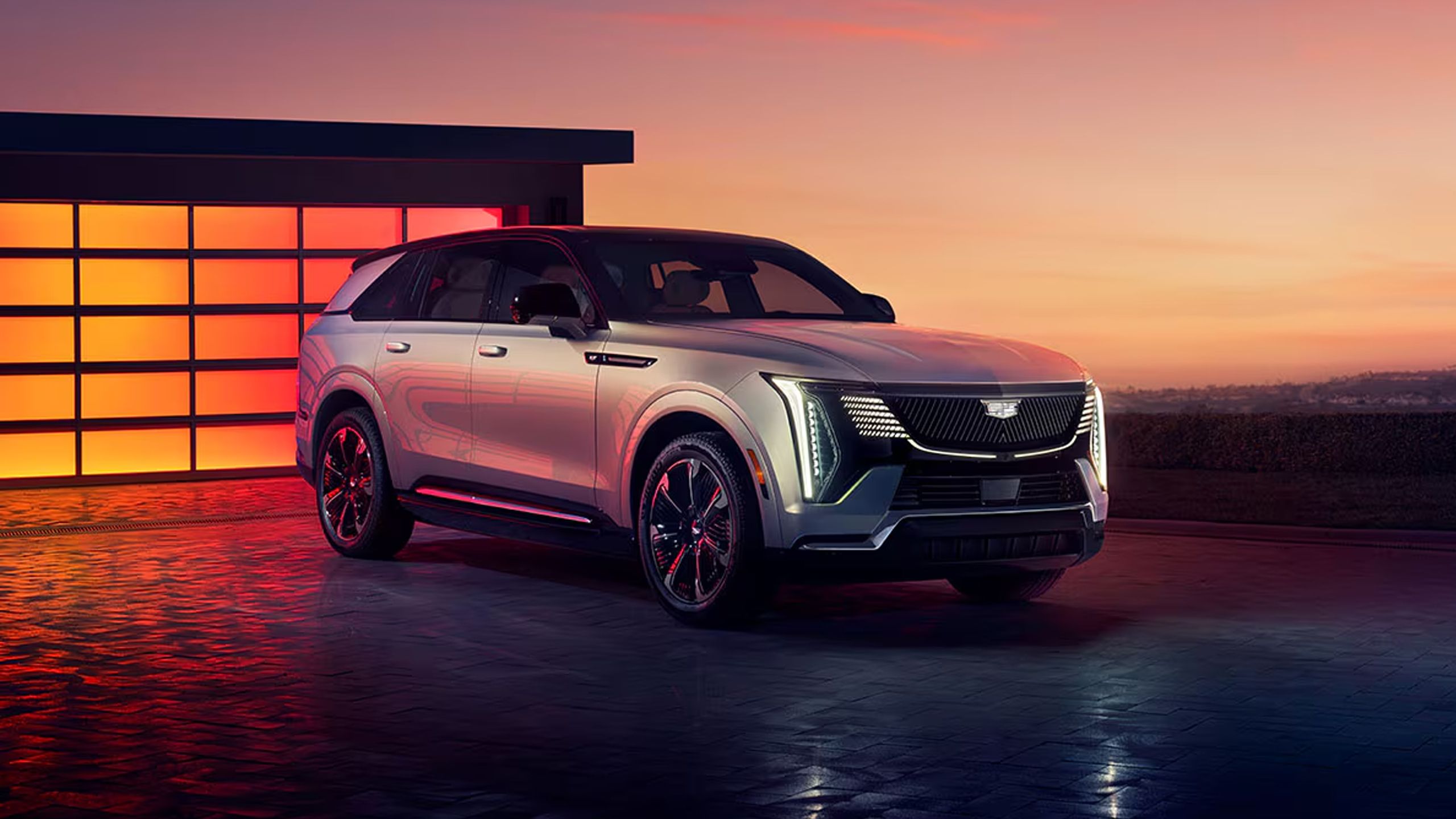 A still photo of the Cadillac Escalade IQ in a driveway at sunset. 
