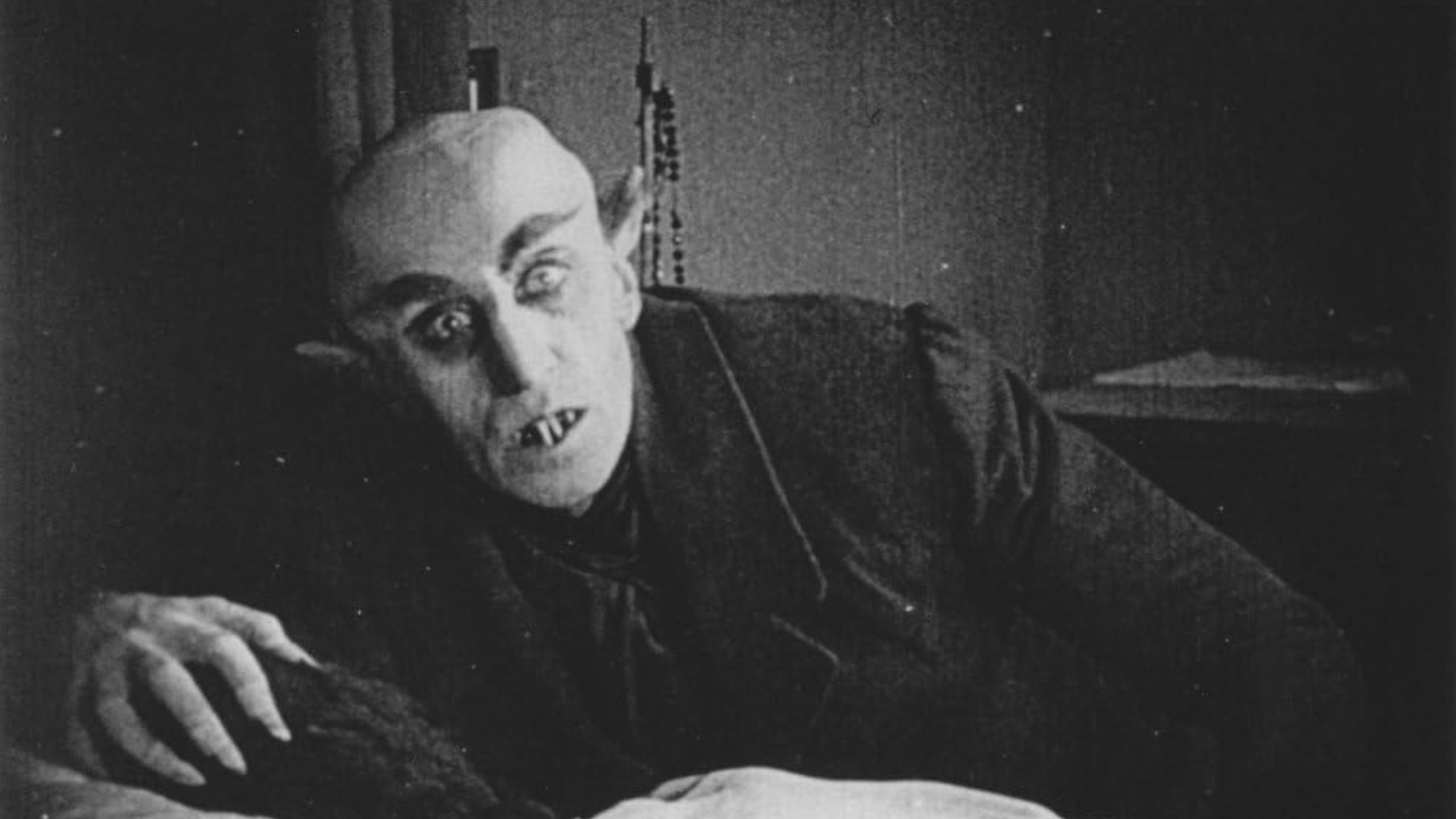 Nosferatu about to suck blood