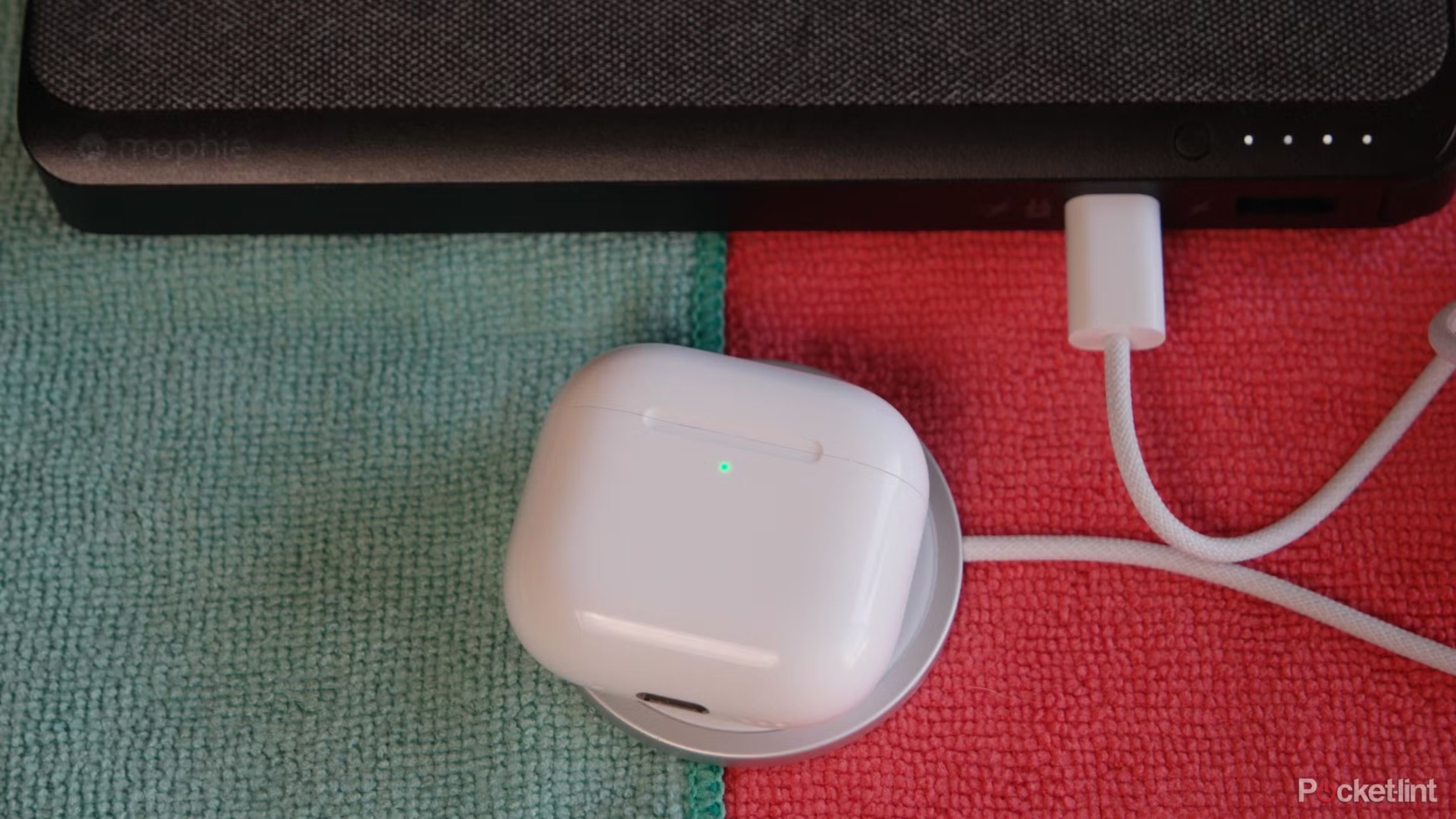 AirPods 4 with anc on MagSafe charger connected to a mophie power bank.