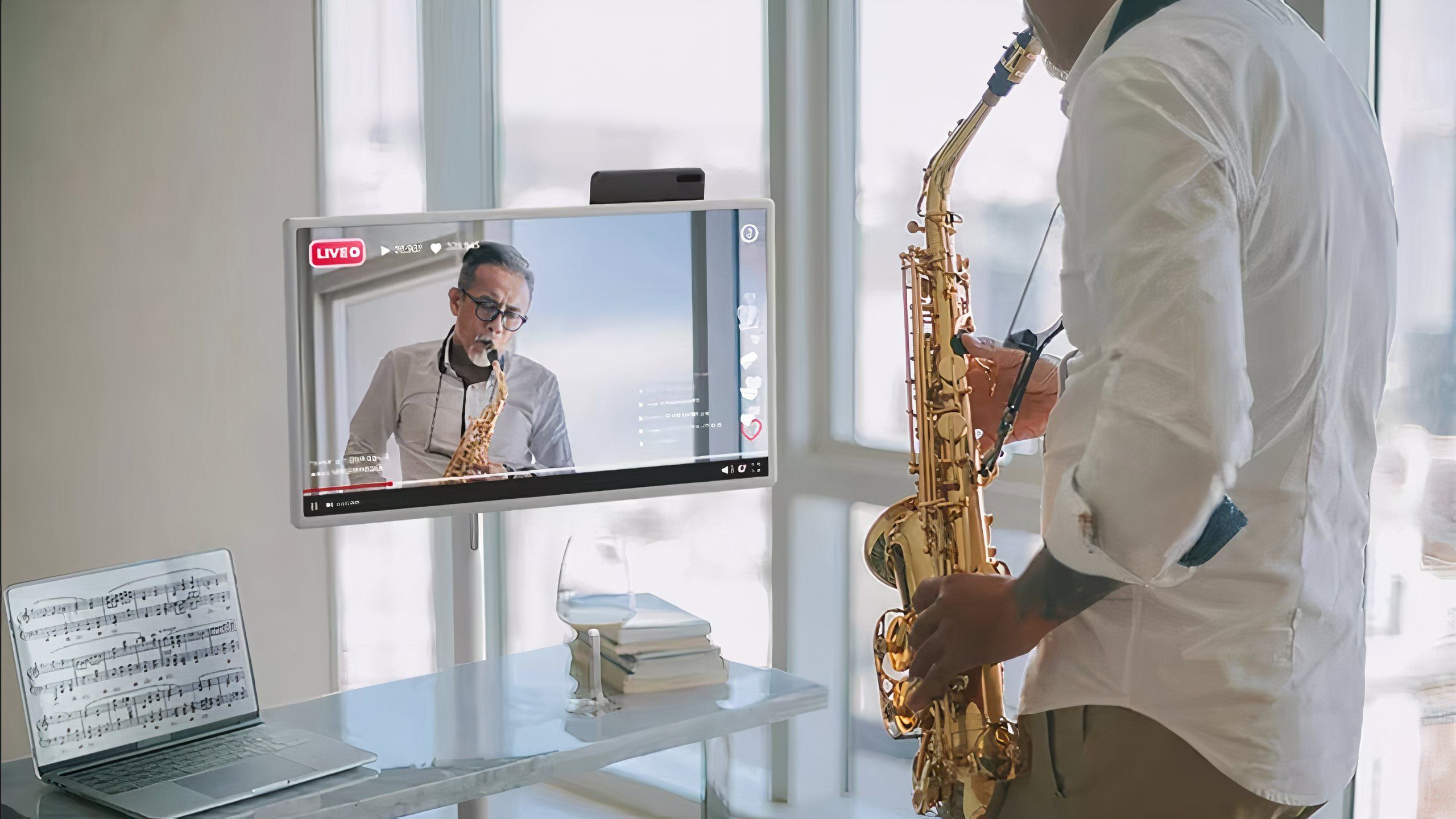 Person playing saxophone watching someone on TV play saxophone