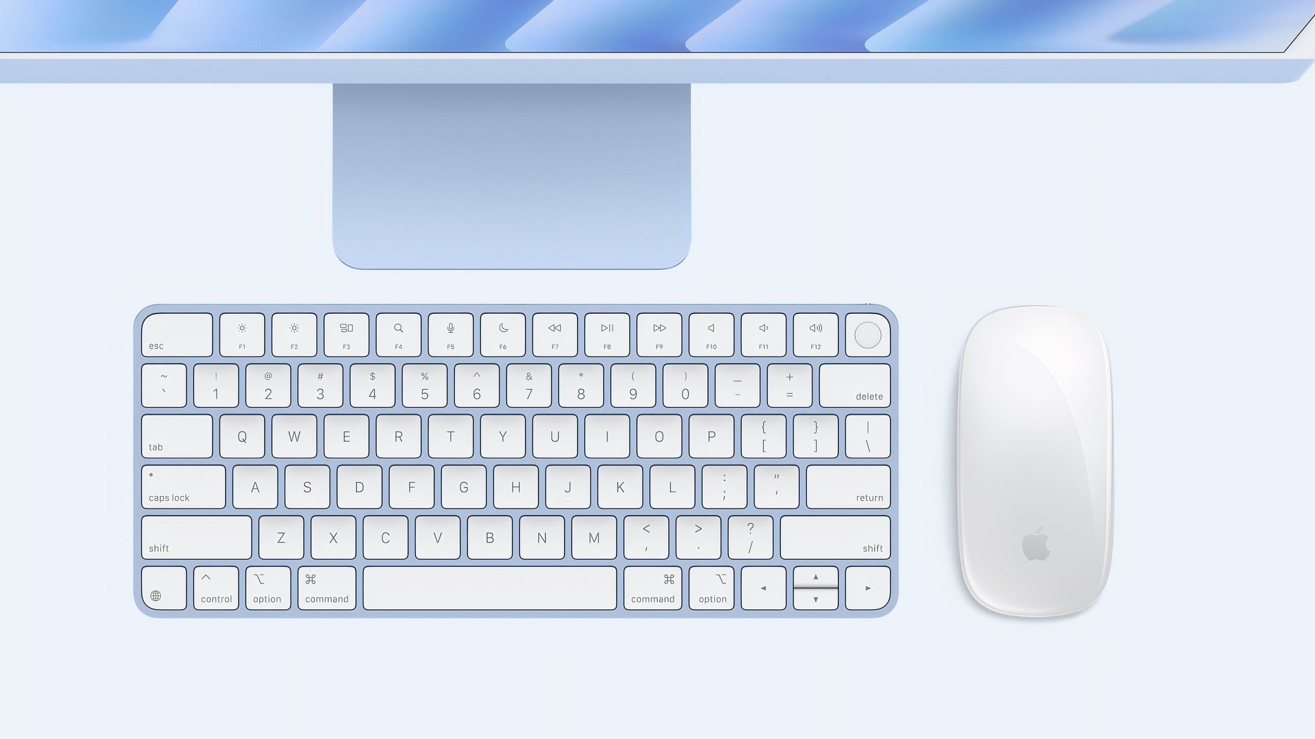 A blue Magic Keyboard and Magic Mouse in front of a new M4 iMac.