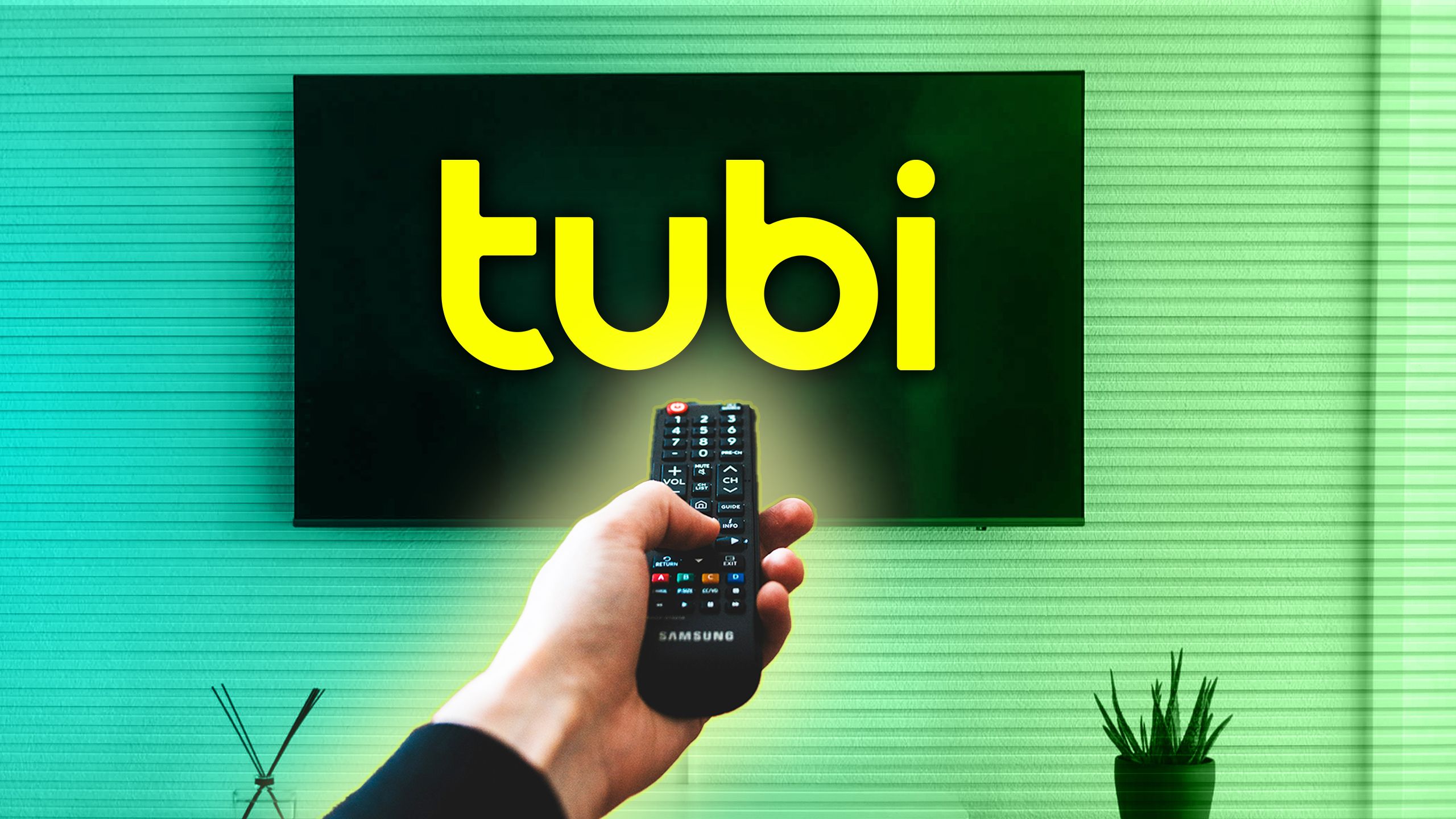 A person pointing a remote at a TV with the Tubi logo on it. 