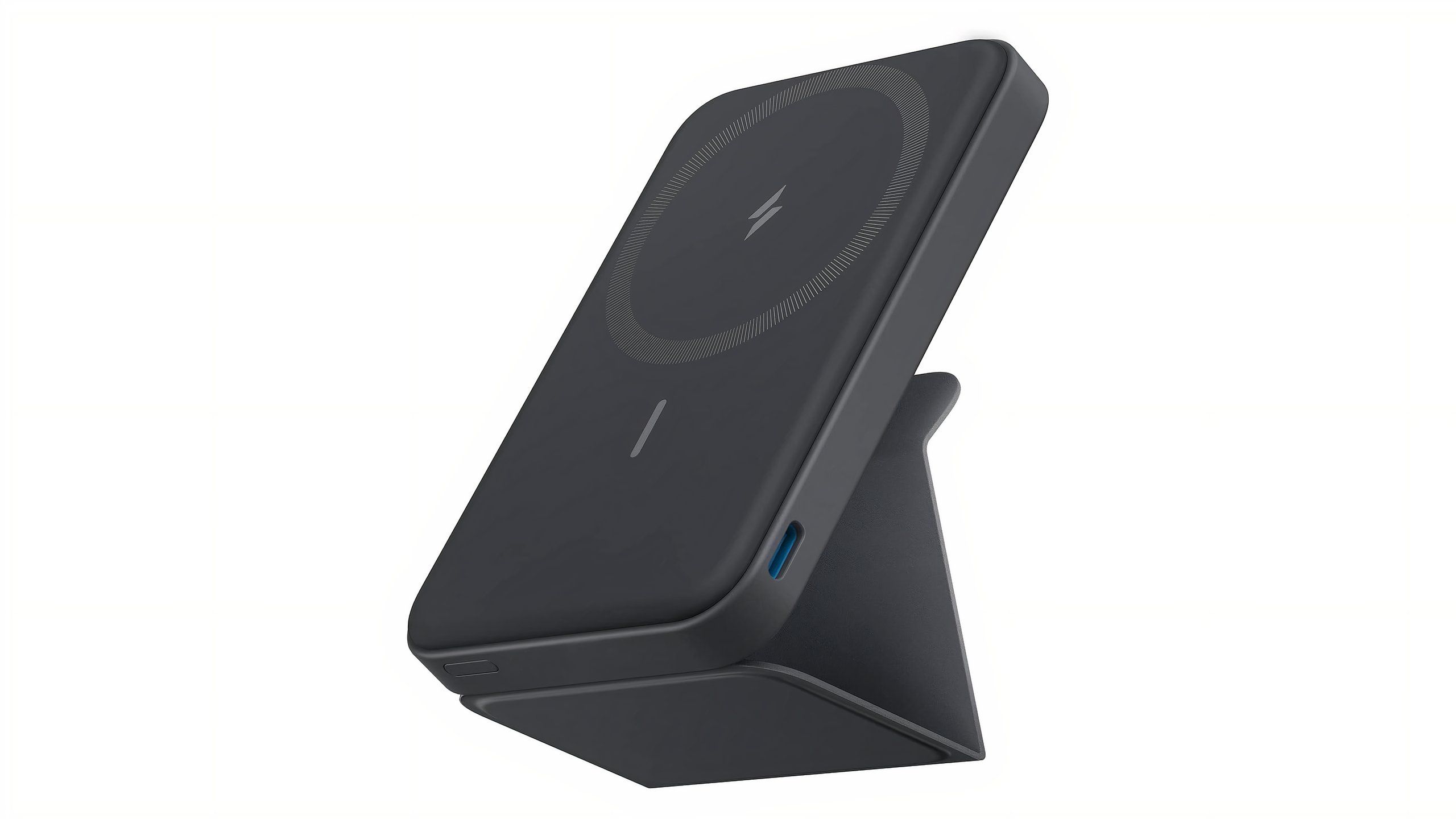 A dark gray battery pack with a USB-C port on the side and a stand on the back.