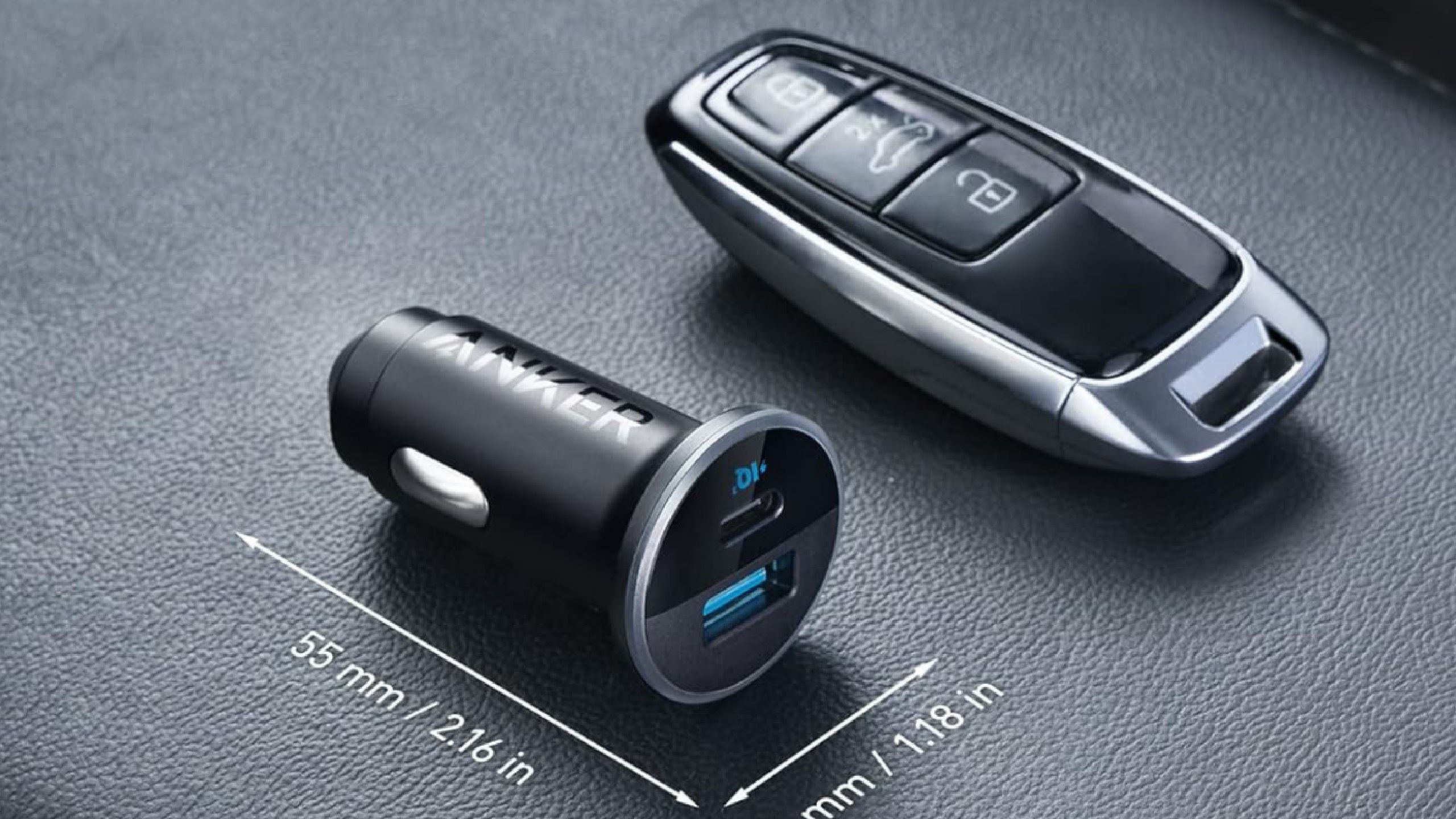 An Anker 323 USB car charger beside a car key. 