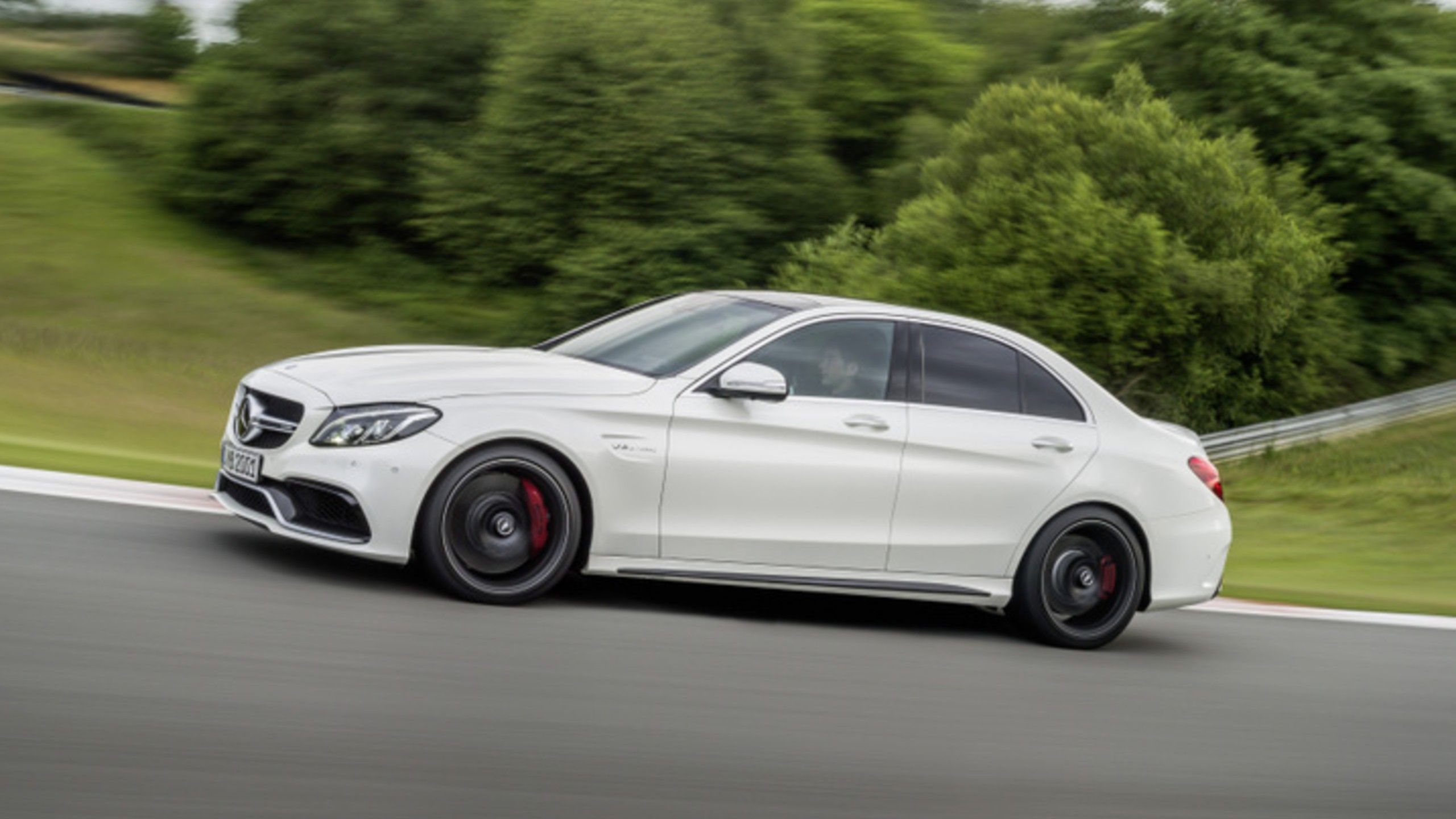 side profile of 2015 Mercedes-Benz C 63 AMG driving on track