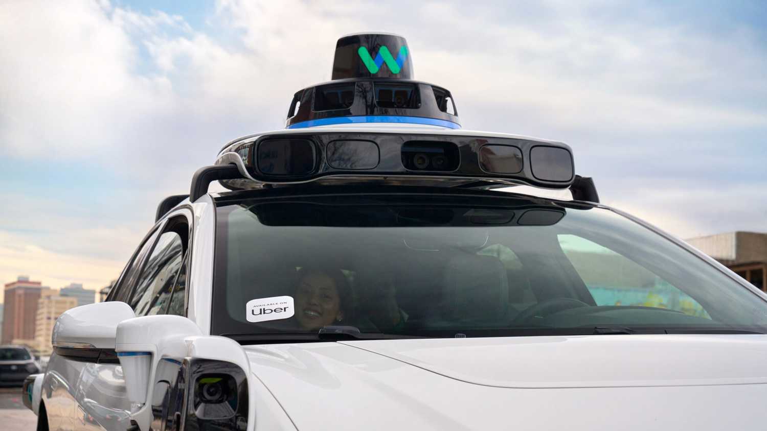 A Waymo with a passenger.