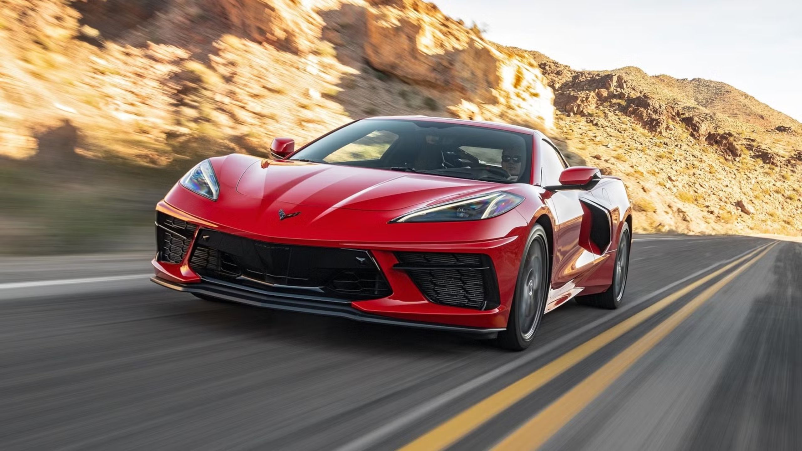 Front view of the 2025 corvette c8 stingray driving on road